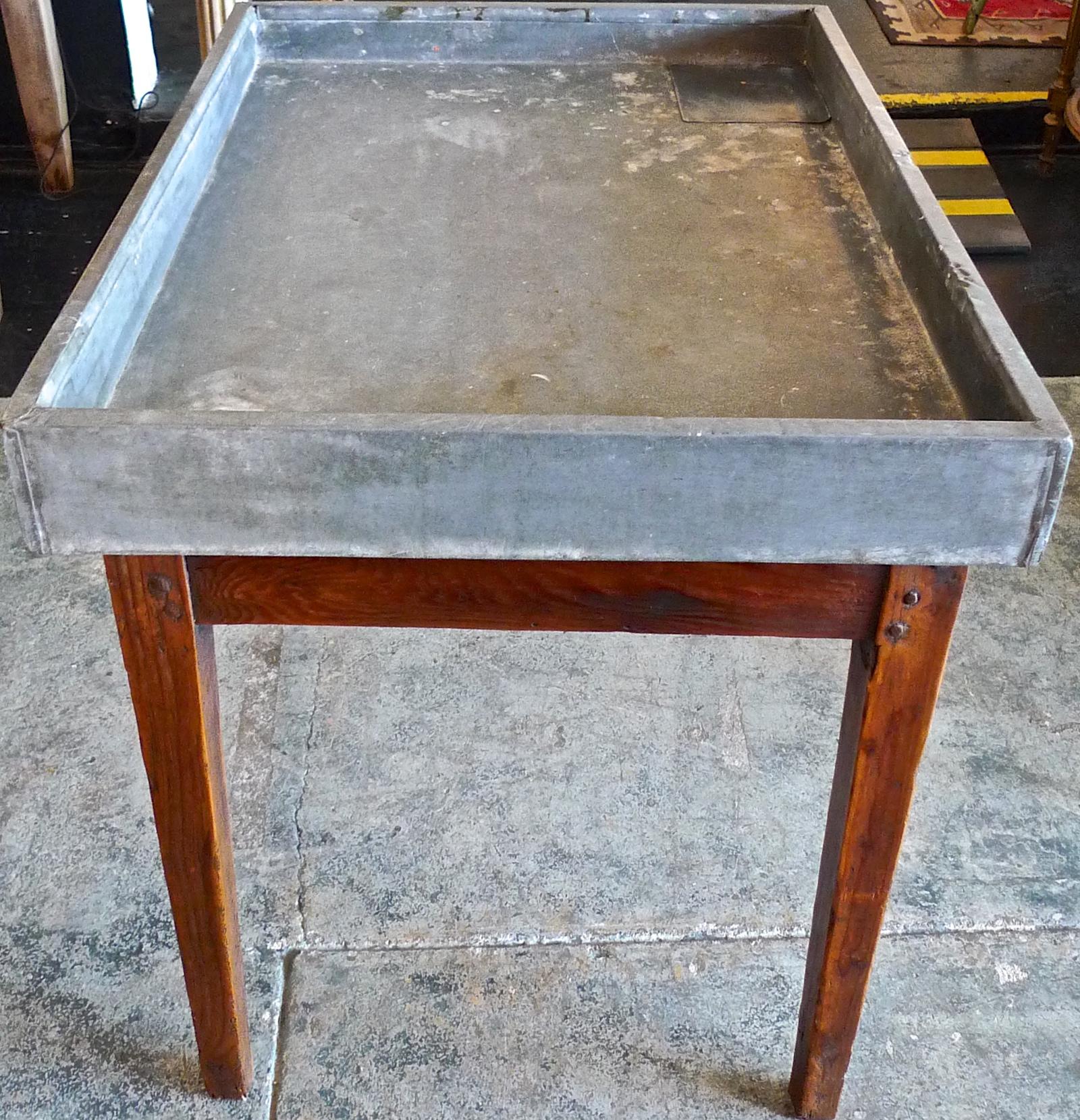 French 19th century zinc top flower or vegetable potting table on a stained wood frame with one corner drainage hole.