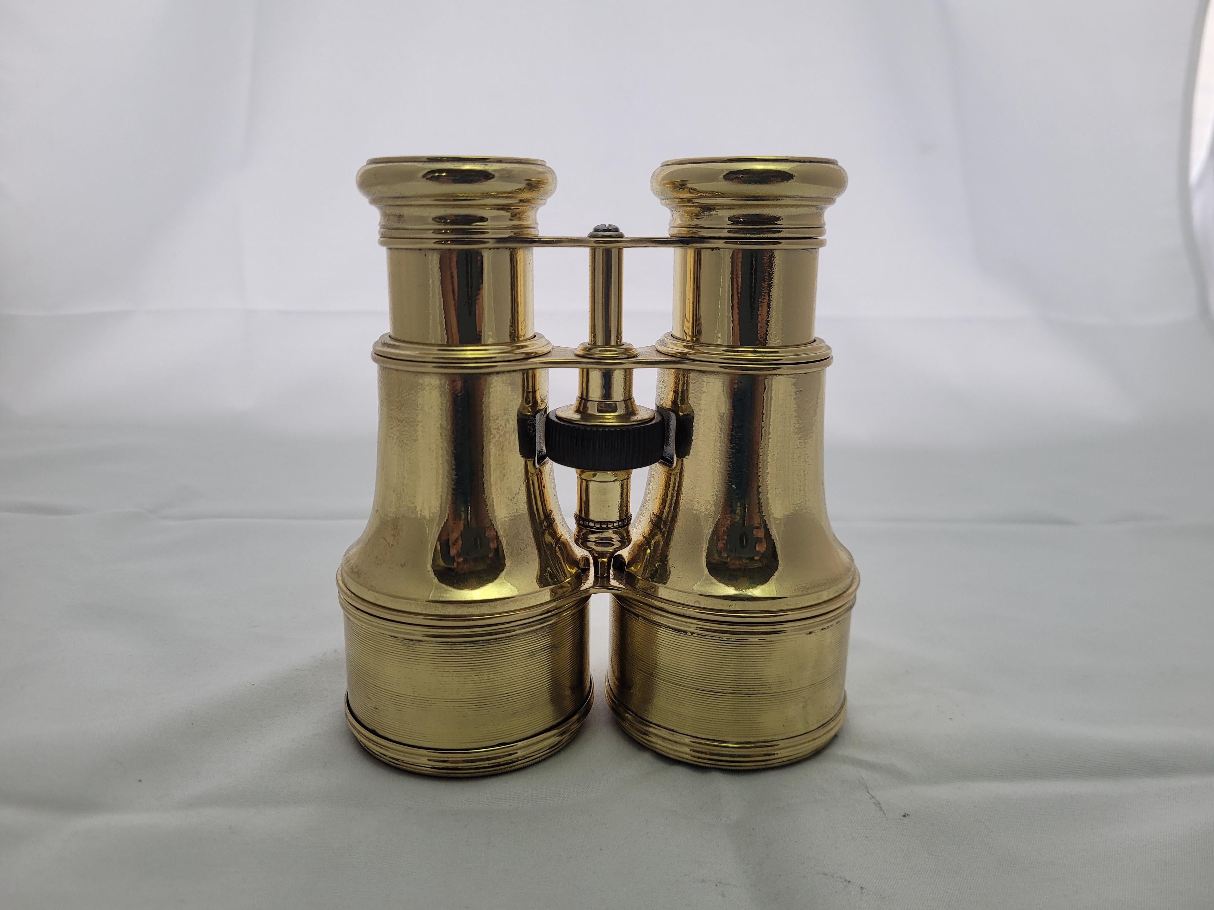 A meticulously polished and lacquered brass binocular with geared focal knob, sunshades, etc.

The eye pieces are marked 