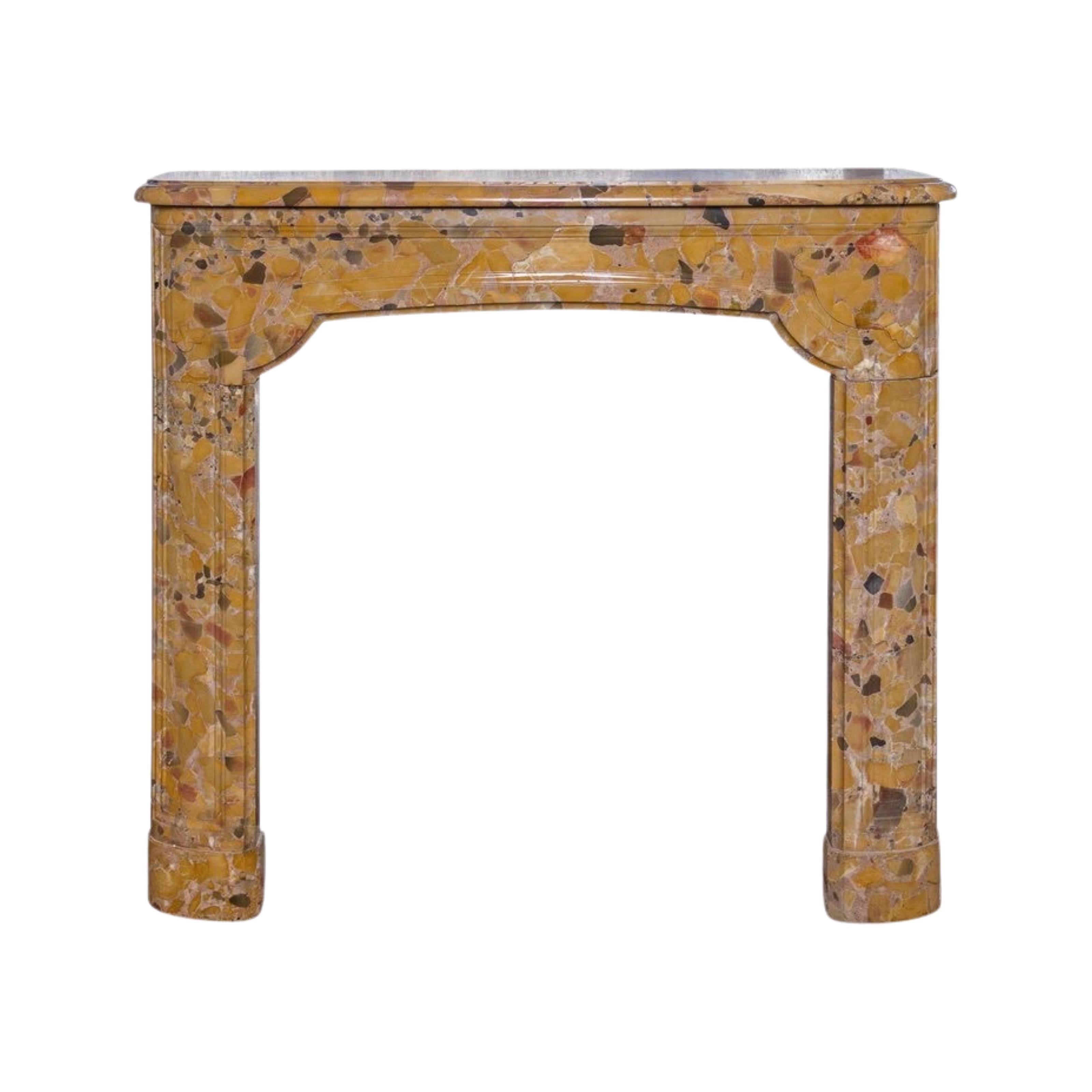This petite chamber-sized mantel is carved in the style of Louis XIV with doucine molding on the front of the traverse and of the legs. The shelf front and sides demonstrate 1.25