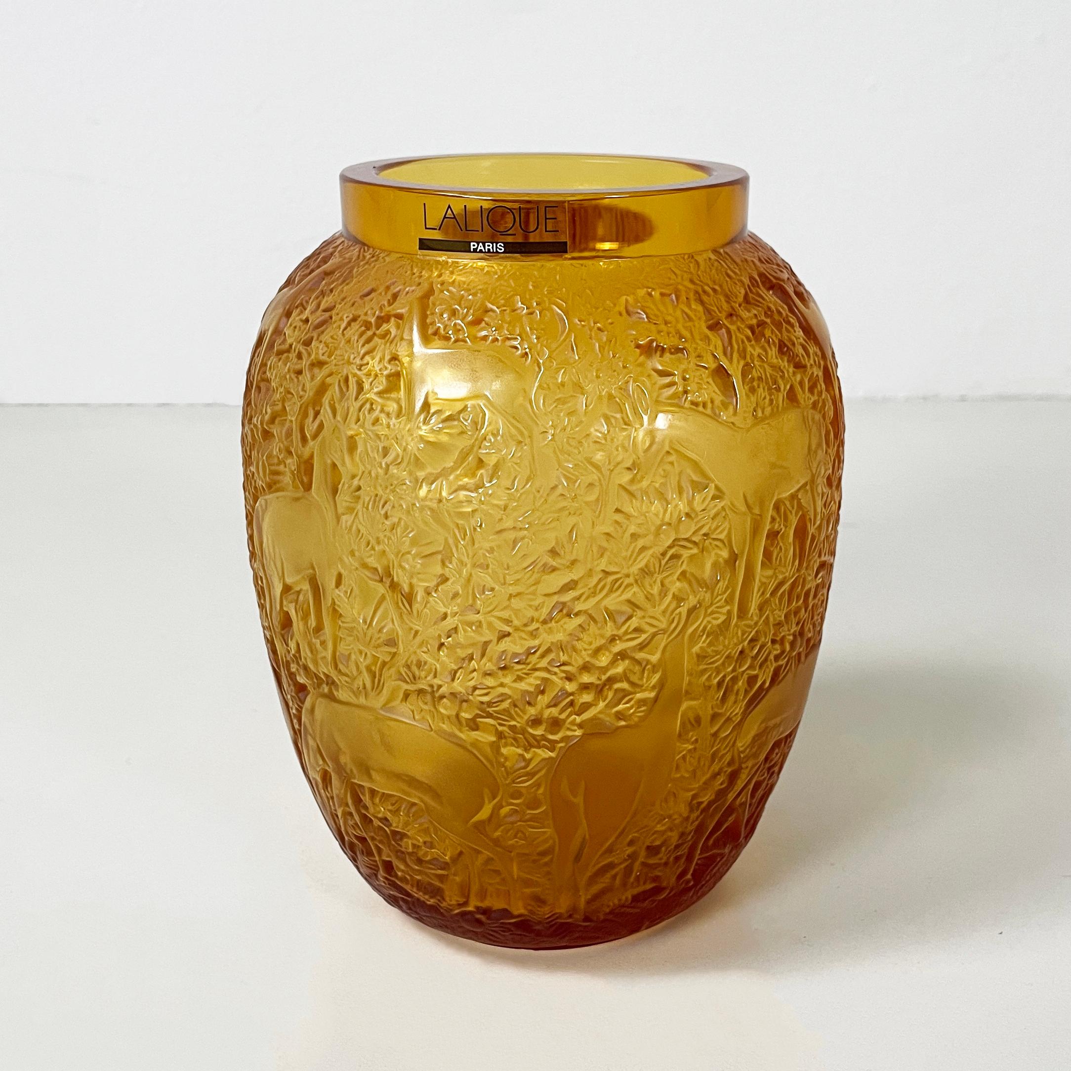 French Yellow glass vase with relief of deer and wood by Lalique, 1900-1990s
Finely crafted vase in yellow-amber glass. The entire profile features a bas relief with deer in the wood. The 