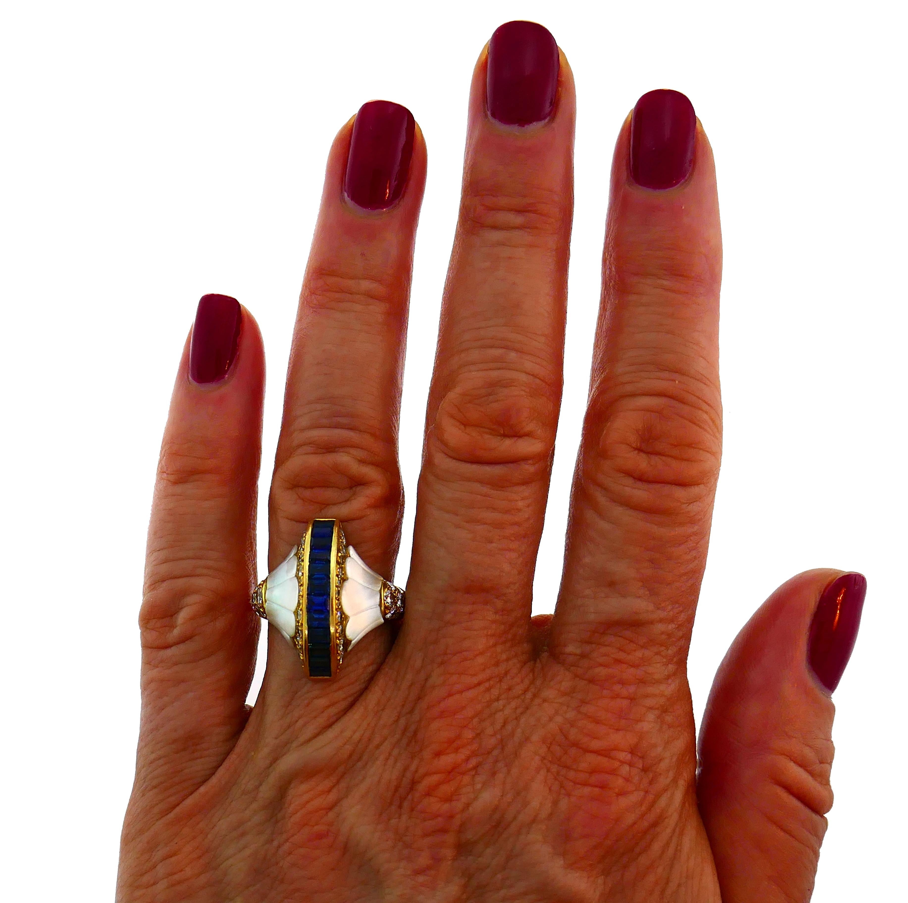 Exquisite cocktail ring made of 18 karat yellow gold, carved mother-of-pearl and accented with eleven emerald cut sapphire (total weight approximately 1.10 carats) and round transitional cut diamonds (F-G color, VS clarity, total weight