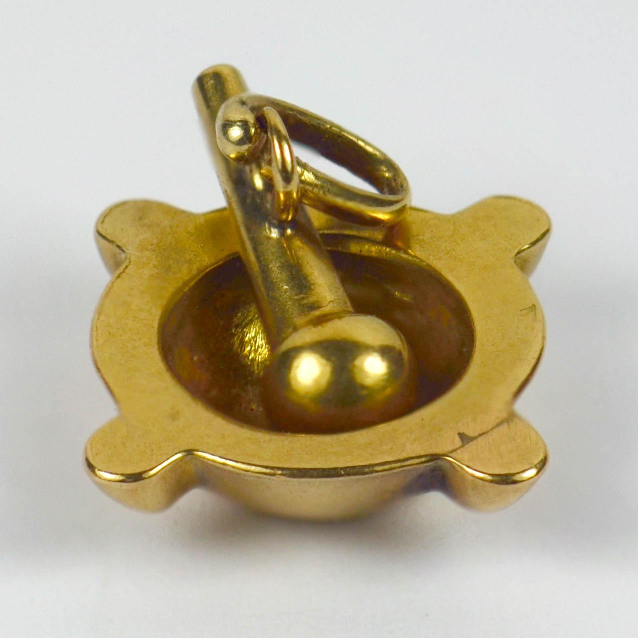 A French 18 karat yellow gold charm pendant designed as a pestle and mortar. Stamped with the eagle's head for 18 karat gold and French manufacture.

Dimensions: 1.5 x 1.5 x 0.7 cm
Weight: 2.62 grams