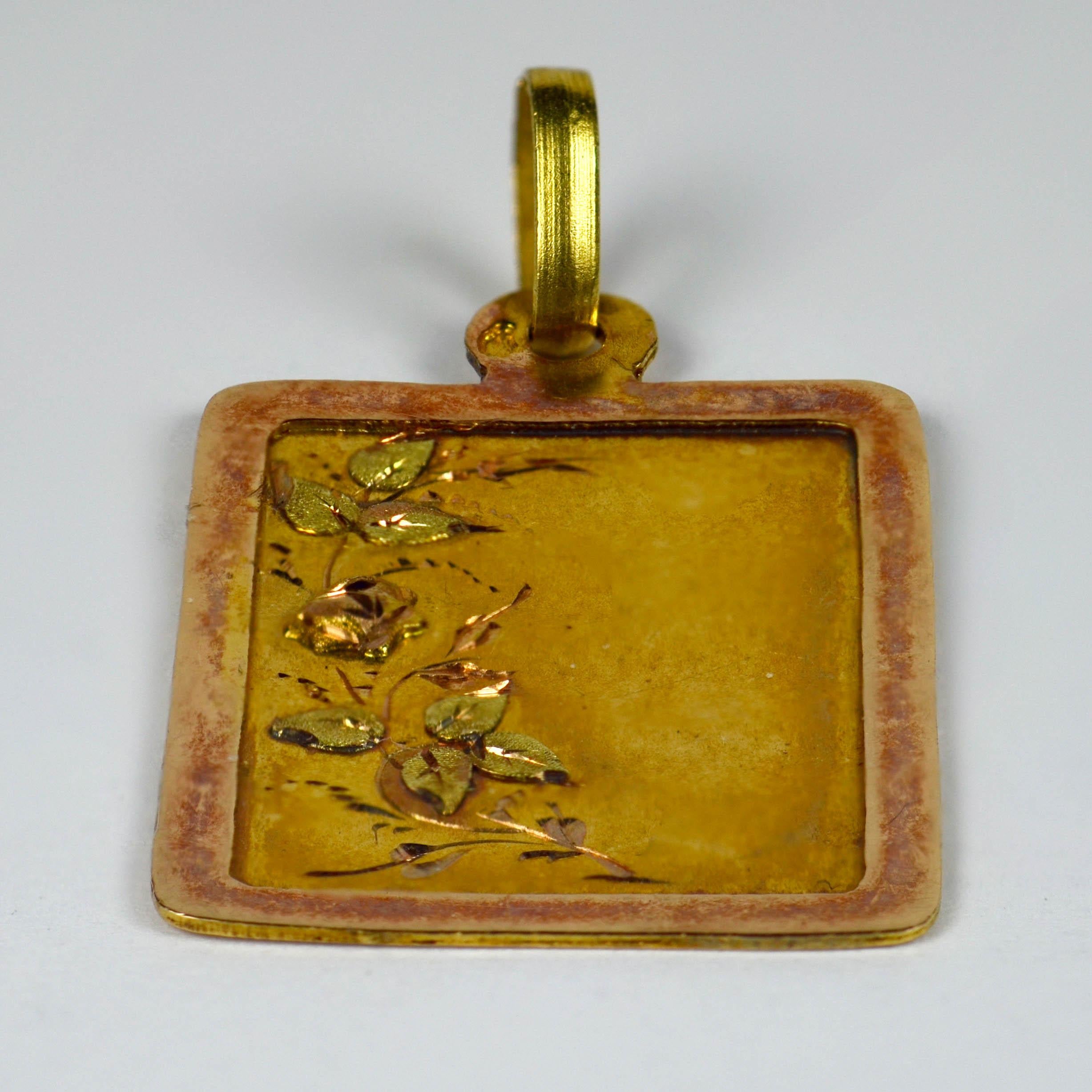 An Art Nouveau French charm or pendant depicting an 18 karat rose gold rectangular frame with a yellow and coloured gold floral decoration within.
Stamped with the eagle's head for 18 karat gold and French manufacture with an unknown makers