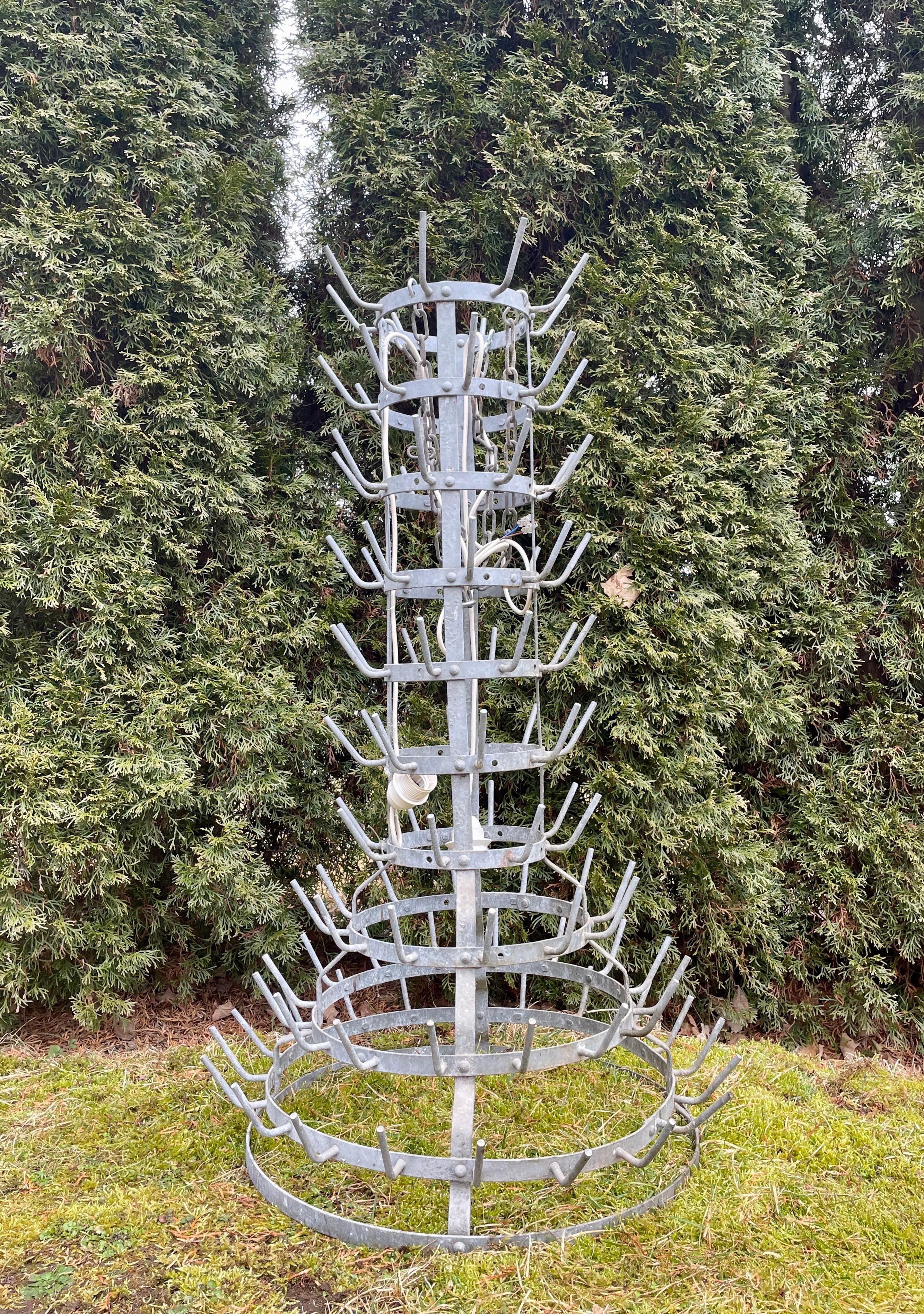 Originally used to dry wine bottles for reuse, this zinc rack is a particularly nice size and form and, with the addition of multiple empty French wine bottles, some with very good vintages (included in the price), can easily be converted into a