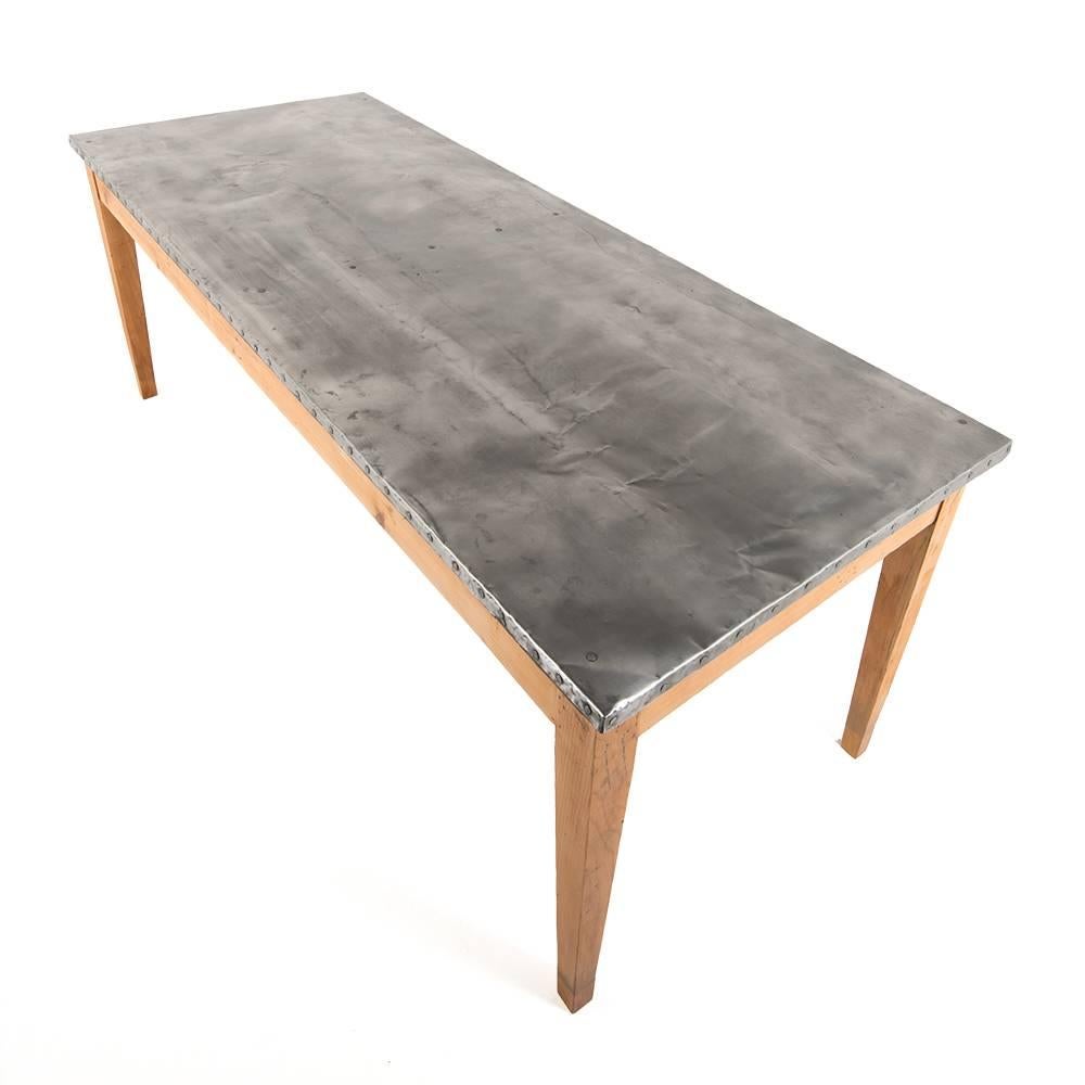 A simple pine vintage French farm or work table with a zinc top.
The deep metal patina contrasts nicely with the lighter pine frame.
 