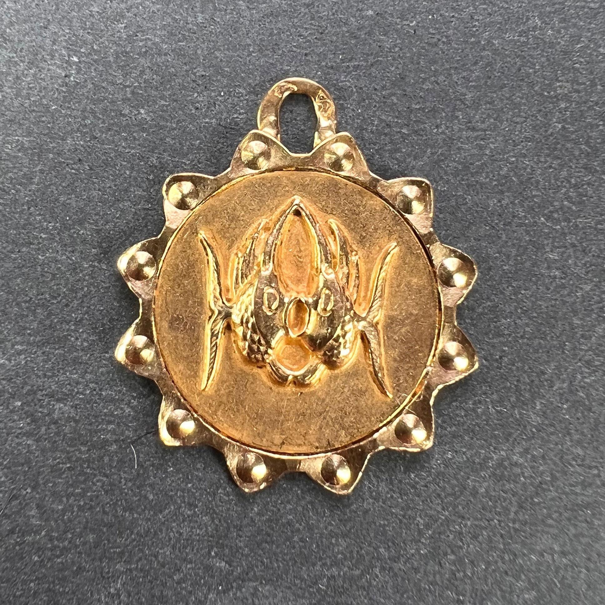 An 18 karat (18K) yellow gold charm pendant designed as the Zodiac sign of Pisces, depicting a pair of fish facing one another. Stamped with the eagle mark for 18 karat gold and French manufacture with makers mark for Perroud.
 
Dimensions: 2.2 x