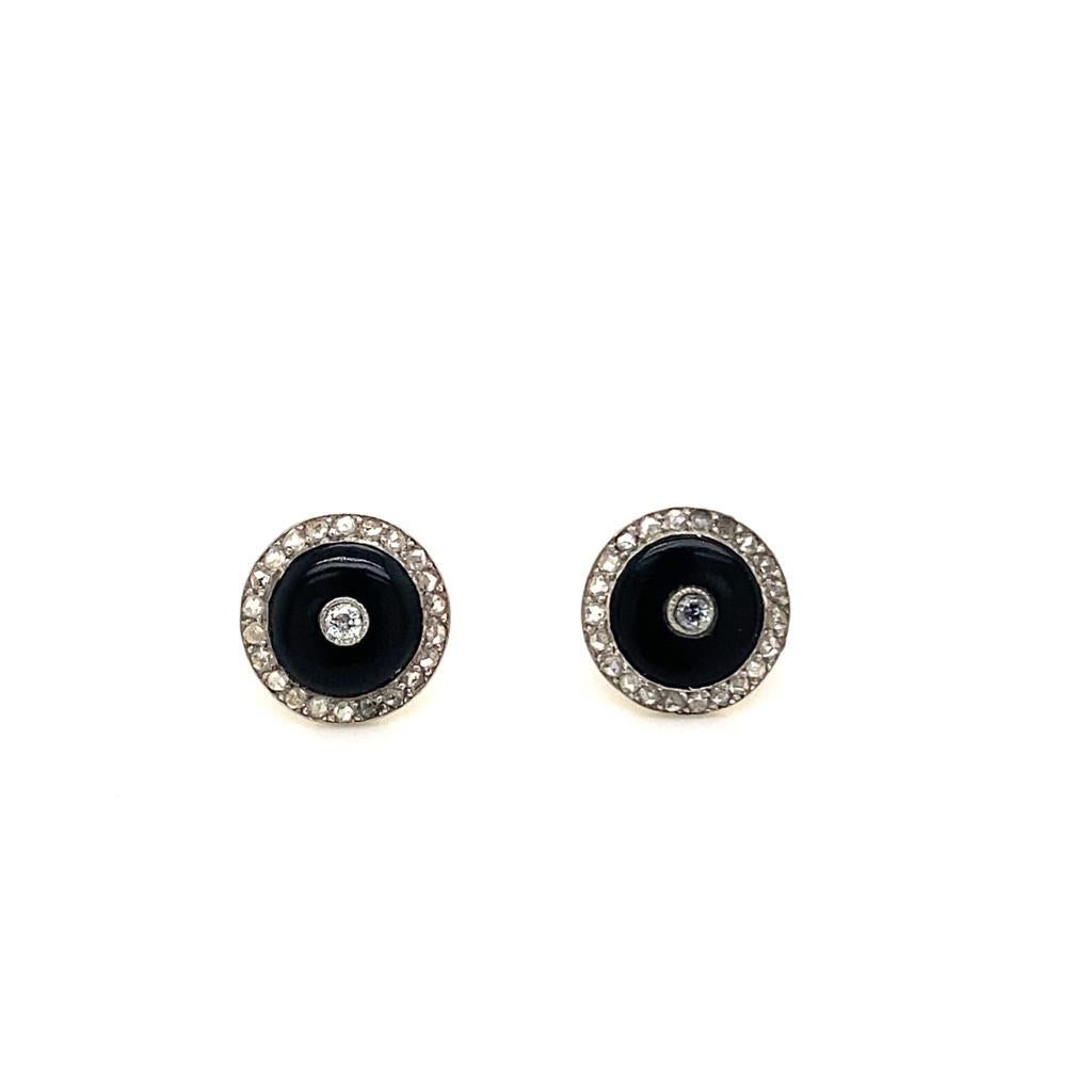 A pair of Art Deco Frere Lacloche platinum onyx and diamond stud earrings, circa 1930.

These elegant earrings are designed as onyx circles within a platinum border set with rose cut diamonds and each centrally set with a further old mine cut