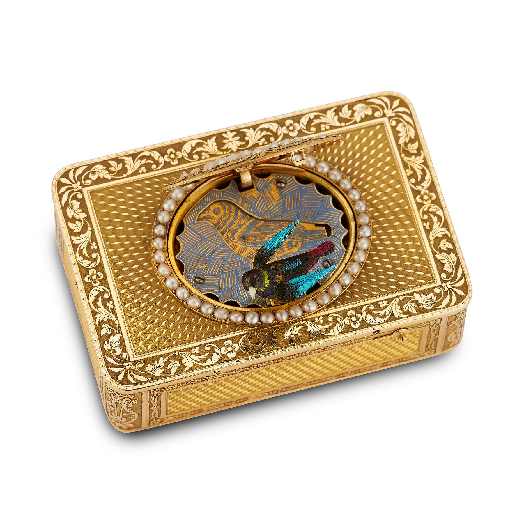 Freres Rochat Gold Bird Box

This stunning gold box was created by Frères Rochat circa 1820. At first glance, it may seem like a well-crafted, beautifully designed snuff box with a pearl floral motif on top. However, it holds a hidden surprise - a