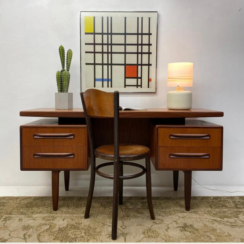 A stunning teak & afromosia desk by British manufacturer G Plan which is part of the fresco range designed in the 1960s by Victor Wilkins. A real midcentury design classic. The floating desk top gives the piece a very light appearance whilst