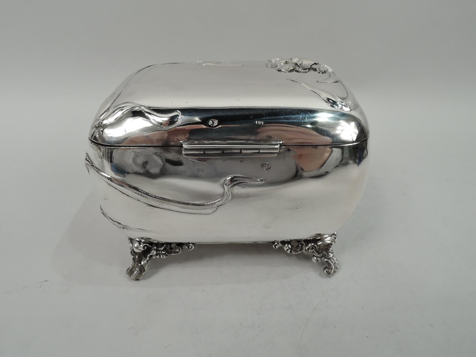 Fresh and pretty turn-of-the-century Austrian Art Nouveau 800 silver casket. Rectangular with curved sides. Cover hinged and raised with scroll tab. Chased and engraved wrapround ornament with entwined and whiplash tendrils and flower heads. Rococo