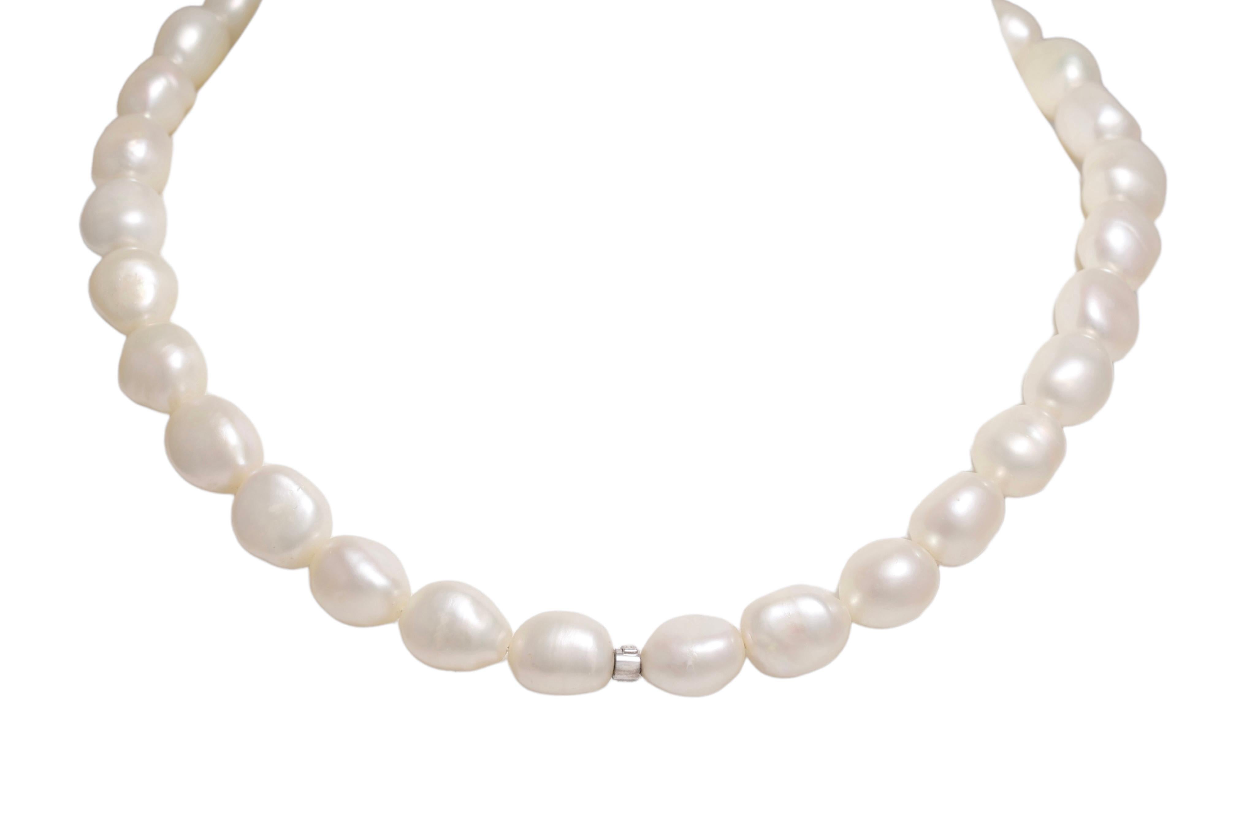 Stunning Fresh Water Baroque Pearl Necklace With Gold Lock Set With Black Diamonds 

Pearls: 31 Fresh water baroque shape, white pearls, each pearl is a different shape but each pearl is approx. in between 12.3 mm x 10 mm

Diamonds: Black diamonds