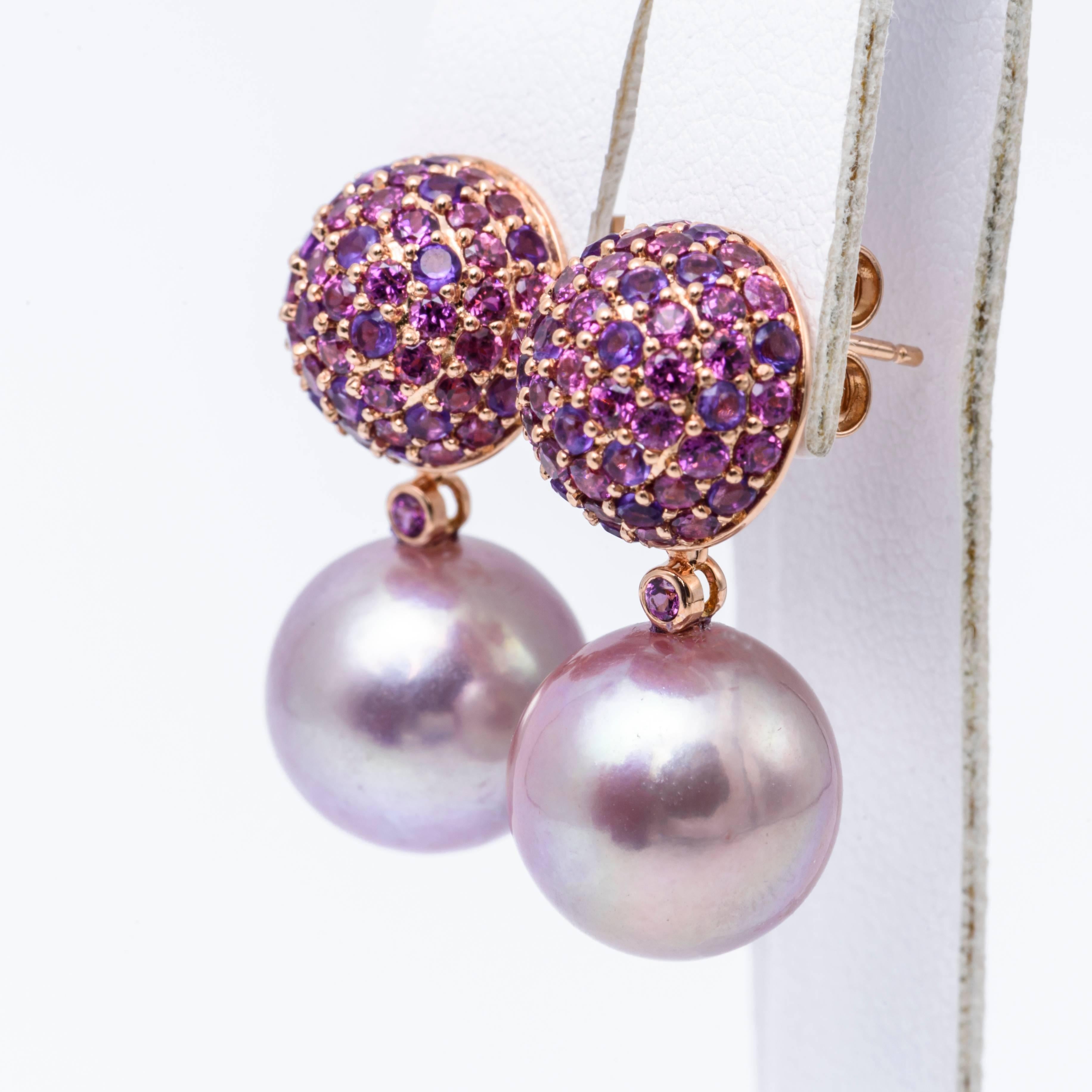 18K Rose gold drop earrings featuring two Fresh water cultured pearl measuring 12-13 mm flanked with Rhodolite, Amethyst in purple and dark pink weighing 2.80 carats.

Pearl Quality	AA
Luster	Excellent
Nacre	Very Thick