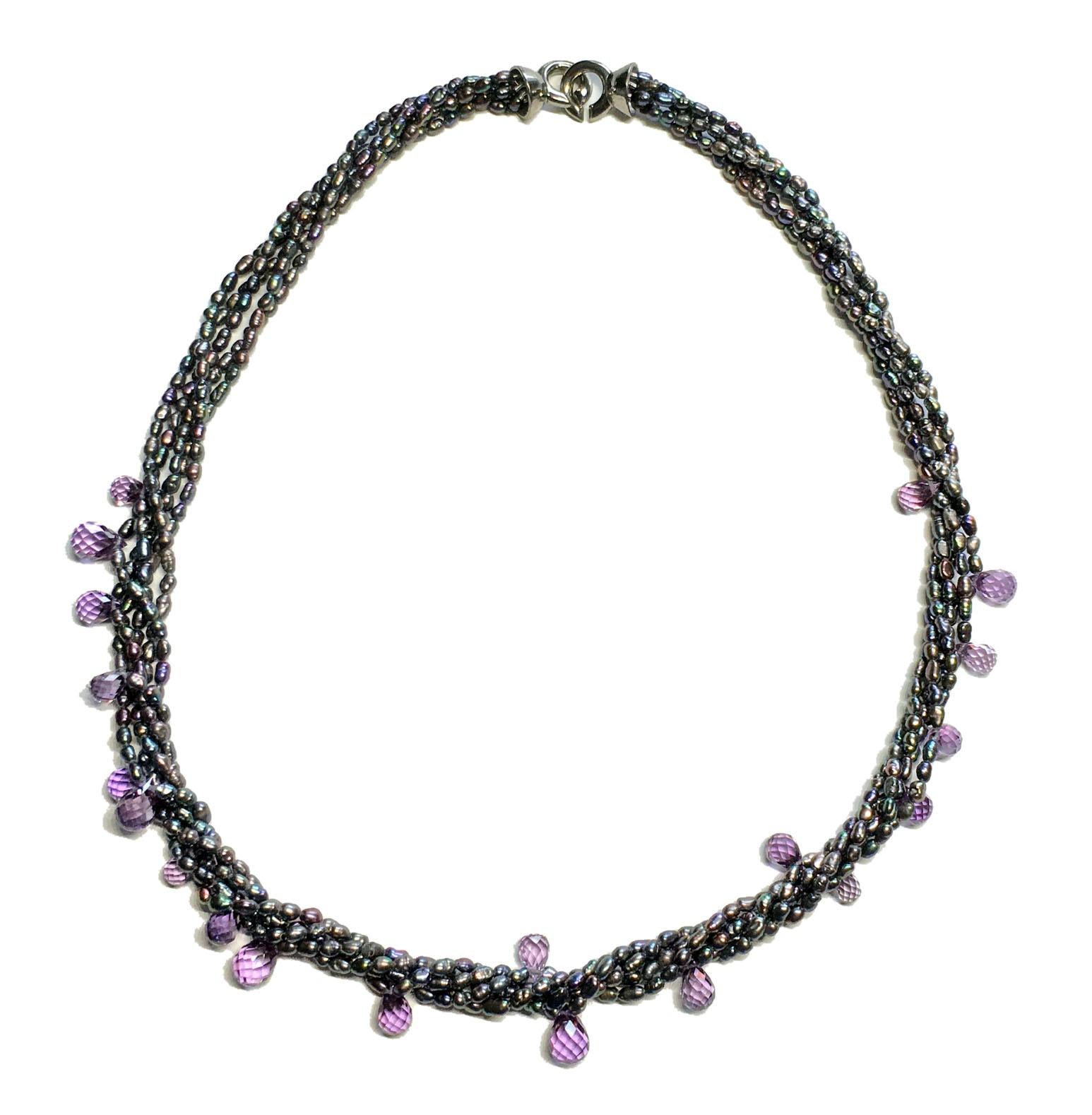 A Fresh Water Pearl, Torsade Necklace, set with Cultured Color Change Sapphire Briolettes. The clasp is a blackened Silver 