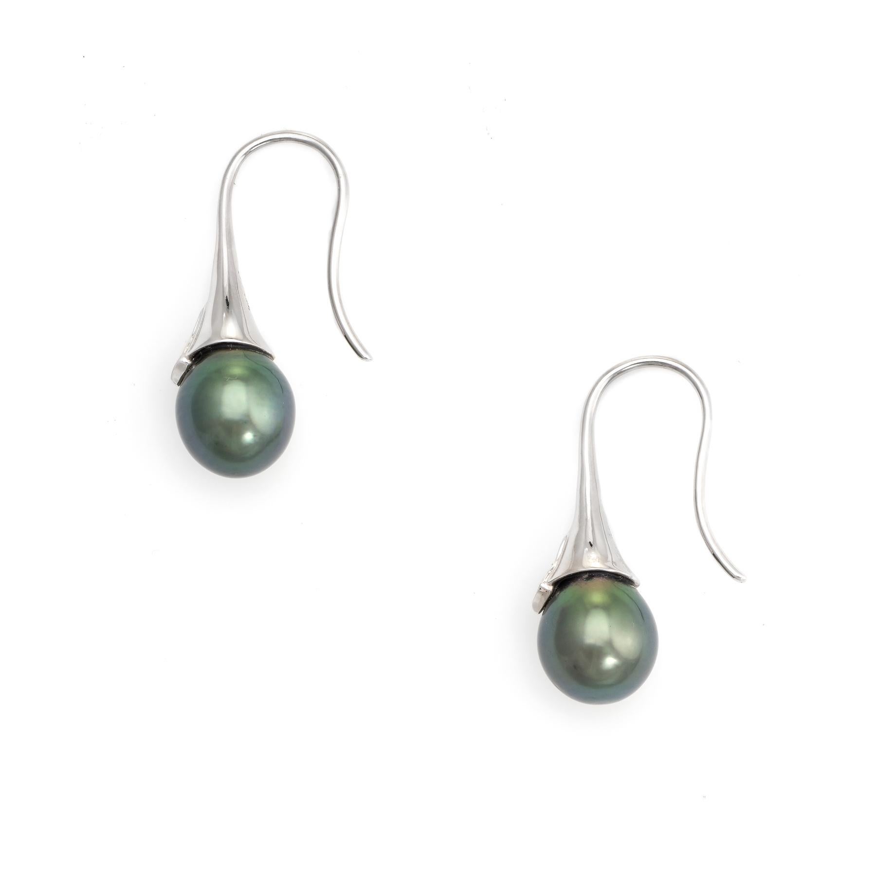 Elegant pair of freshwater black pearl & diamond earrings crafted in 18k white gold. 

Freshwater black pearls each measure 9.5mm, accented with an estimated 0.02 carats of diamonds (estimated at I color and I1 clarity).

The stylish earrings are