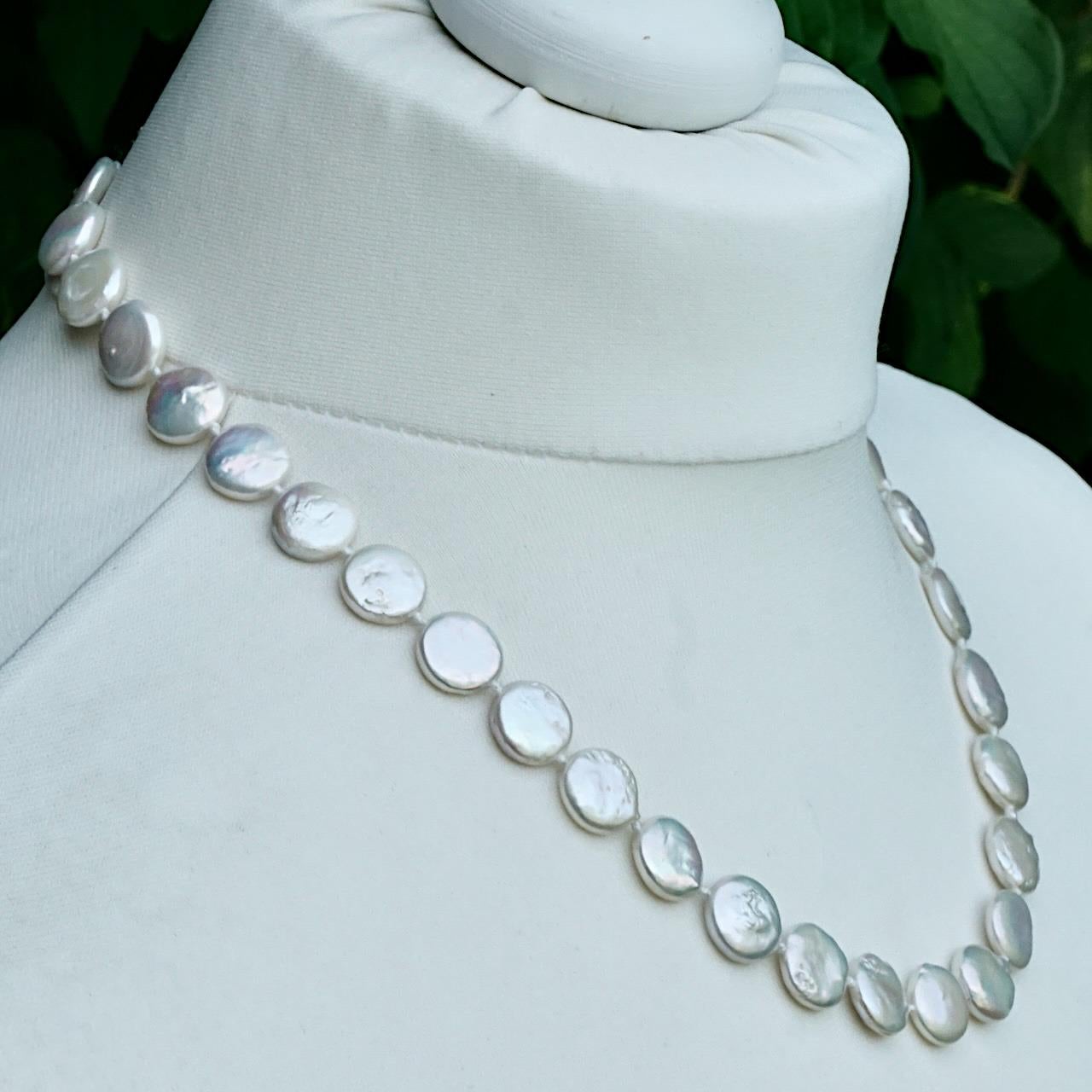 Lovely freshwater coin pearl necklace with a wonderful iridescent lustre. The necklace is knotted between each pearl. Measuring length 52.5 cm / 20.6 inches, and the pearls are 1.3 cm.

This beautiful and classic coin pearl necklace would be perfect