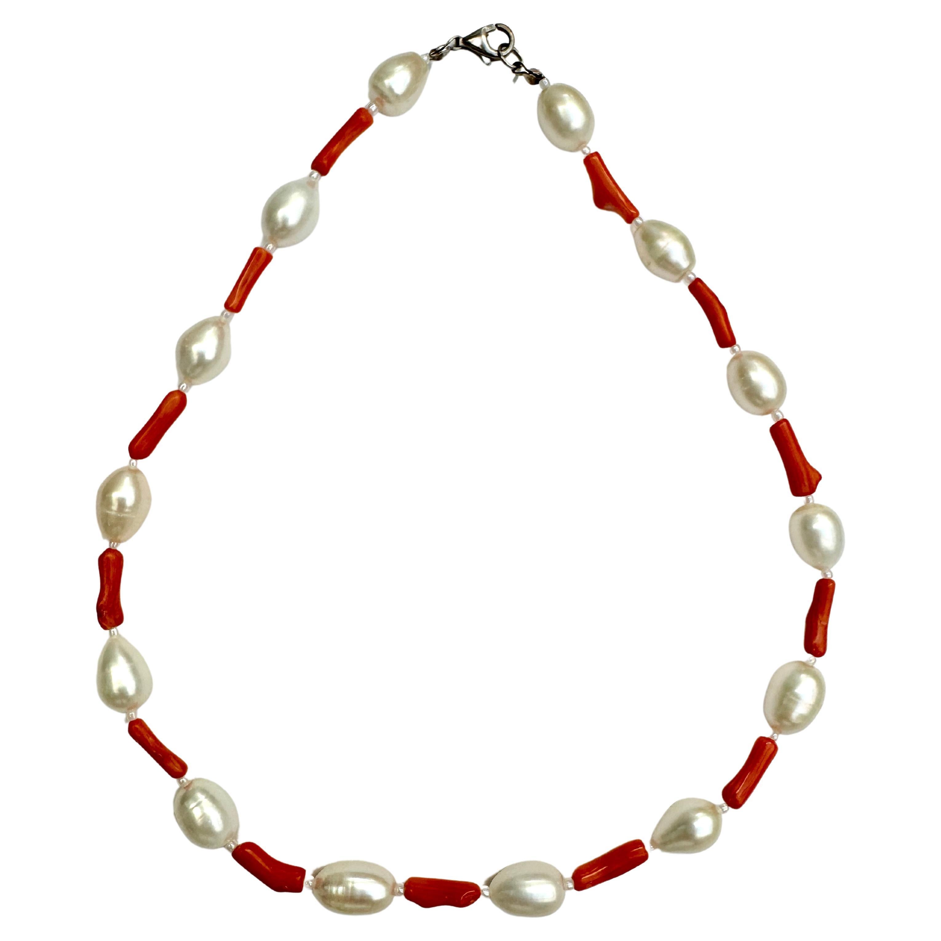 Freshwater oval pearl and coral necklace and earrings set.
Handmade one of a kind delicate natural white luster oval pearls with salmon coral, and small seed pearls, sterling silver clasp. About 16
