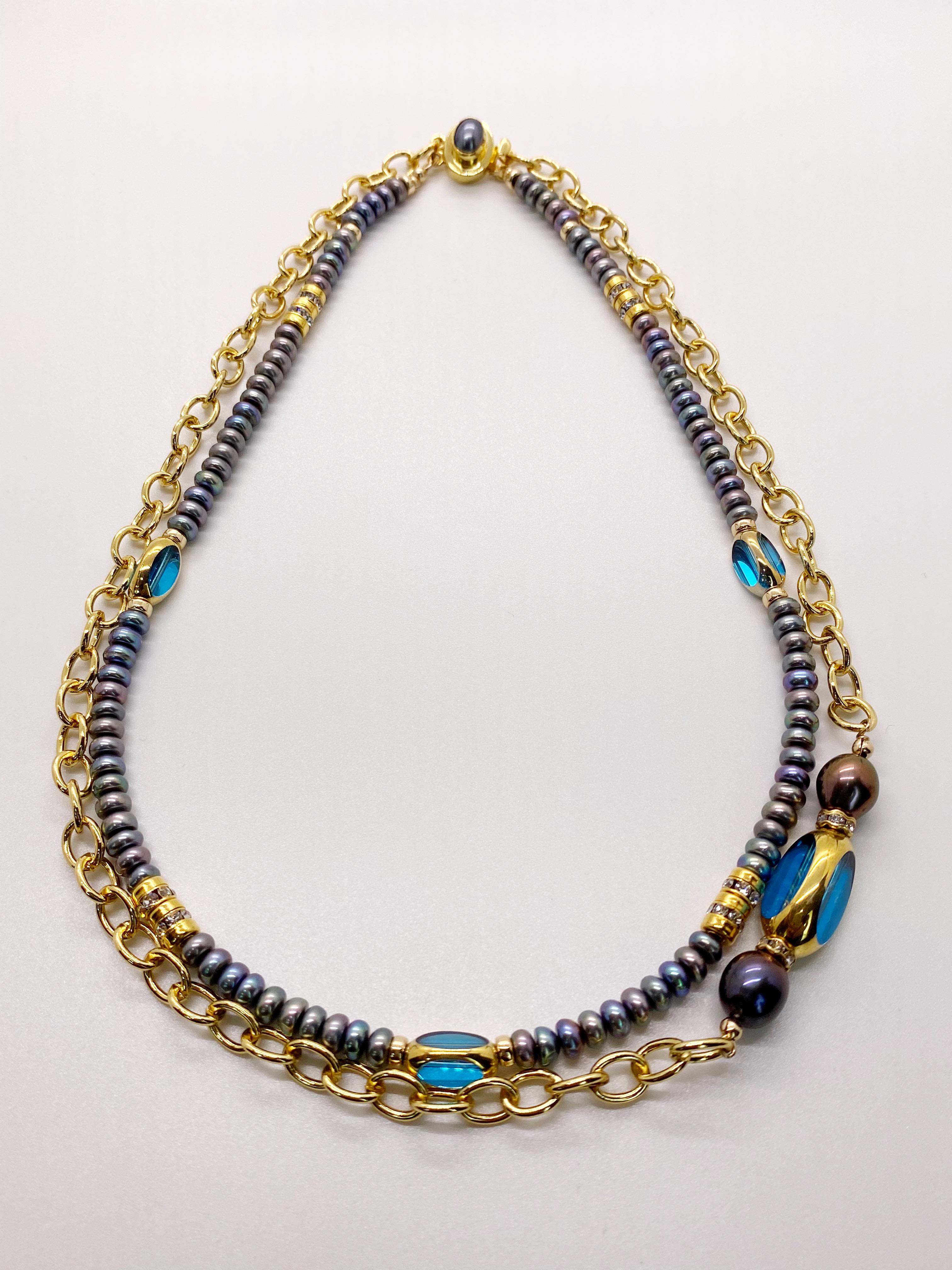 A one of a kind piece.

This necklace offers two strands on a Freshwater Peacock Pearl Vermeil Clasp. One strand is made of Freshwater Peacock Button shaped Pearls adorned with Swarovski Rhinestones, 14K gold filled roundelle beads and 24K Gold