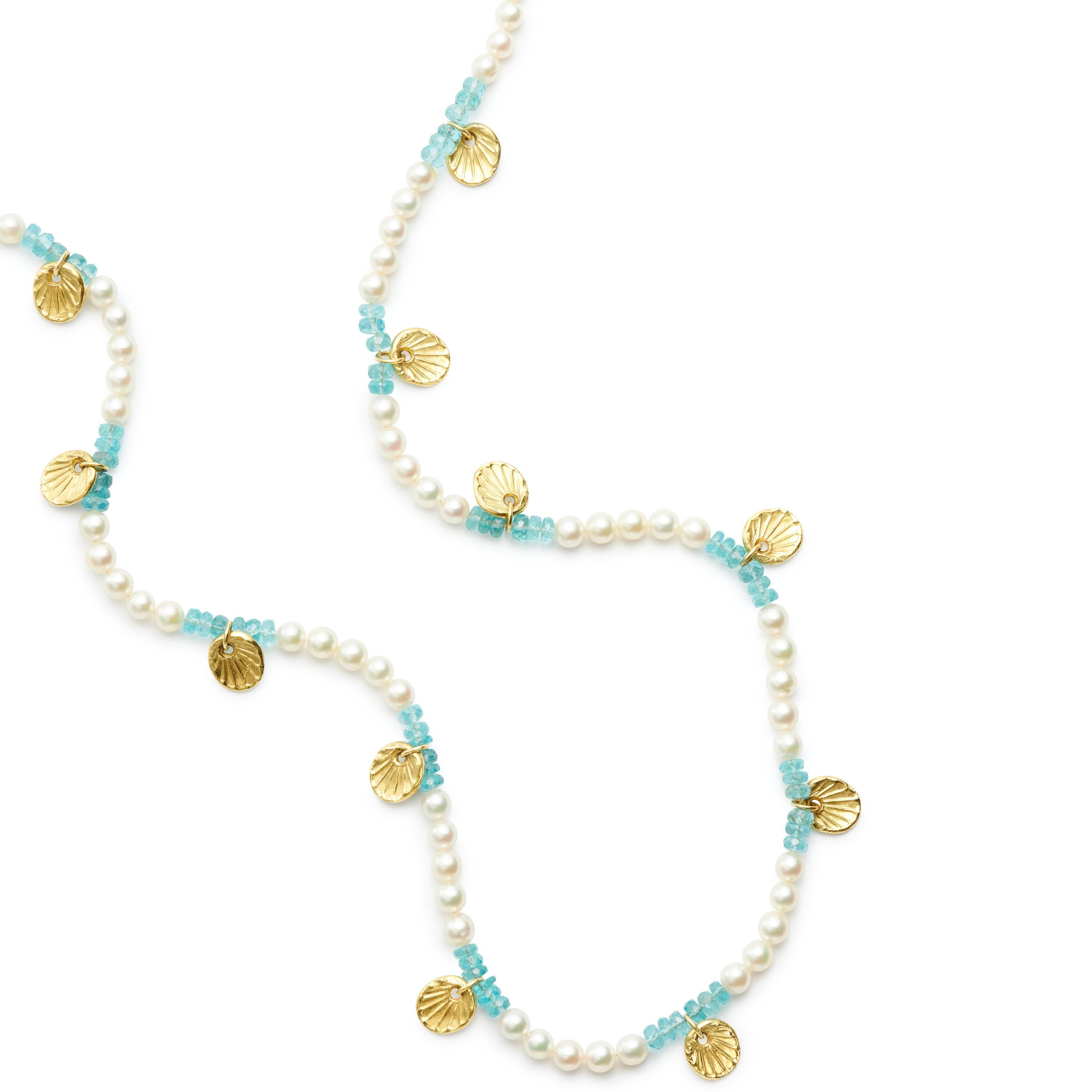 A fancy and fun 26-inch Freshwater Pearl and faceted Apatite Bead Necklace accented with 18 Karat Gold Scallop Shell charms. A sweet summer piece to wear with everything from shorts to sundresses. Finished with an 18 Karat Gold clasp. Match up with