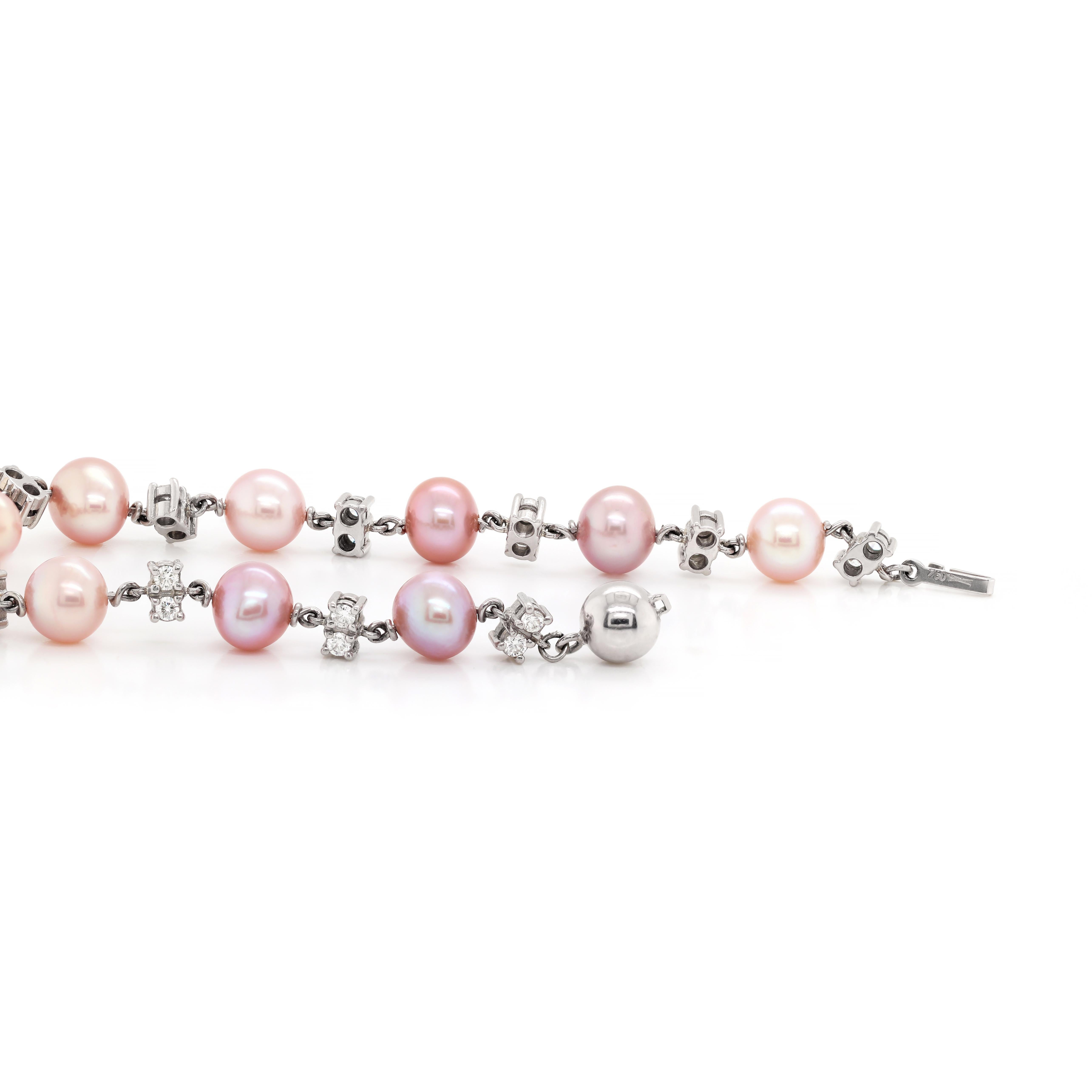 This elegant bracelet features ten round rosé coloured freshwater pearls, beautifully accompanied by 22 round brilliant cut diamonds, two in between each pearl, mounted in four claw open back settings.The total diamond weight in the bracelet comes