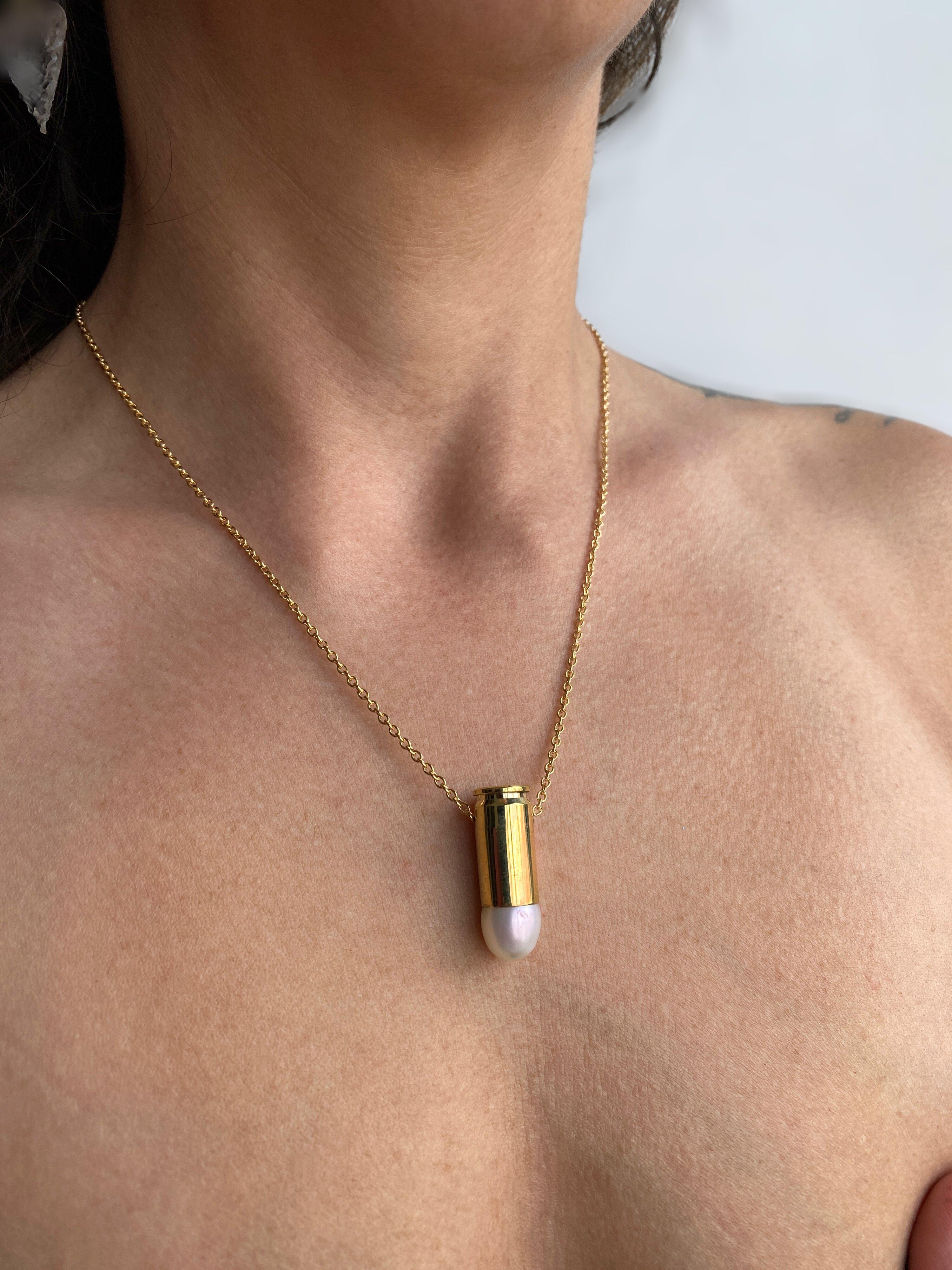 This captivating necklace features a 9mm gold filled bullet casket set with freshwater pearl. This piece is from the “Peace” collection by Sebastian Jaramillo, commemorating the signing of peace between the Colombian guerrillas and the state,