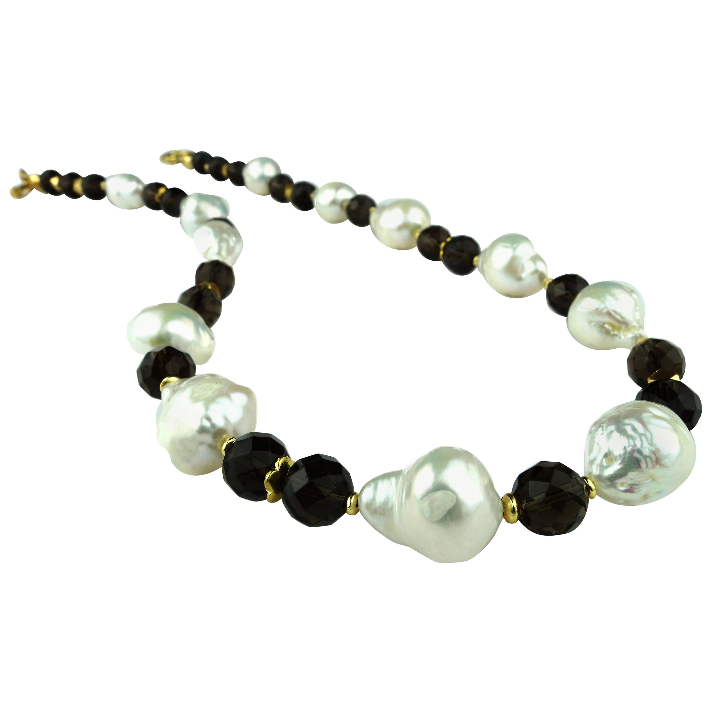 Own the jewelry you wish for

Custom made, striking necklace of white Freshwater Pearls ﻿and round faceted Smoky Quartz.  Each of these Freshwater Pearls is unique in shape and approximately 15mm.  The round faceted Smoky Quartz of 9mm is accented