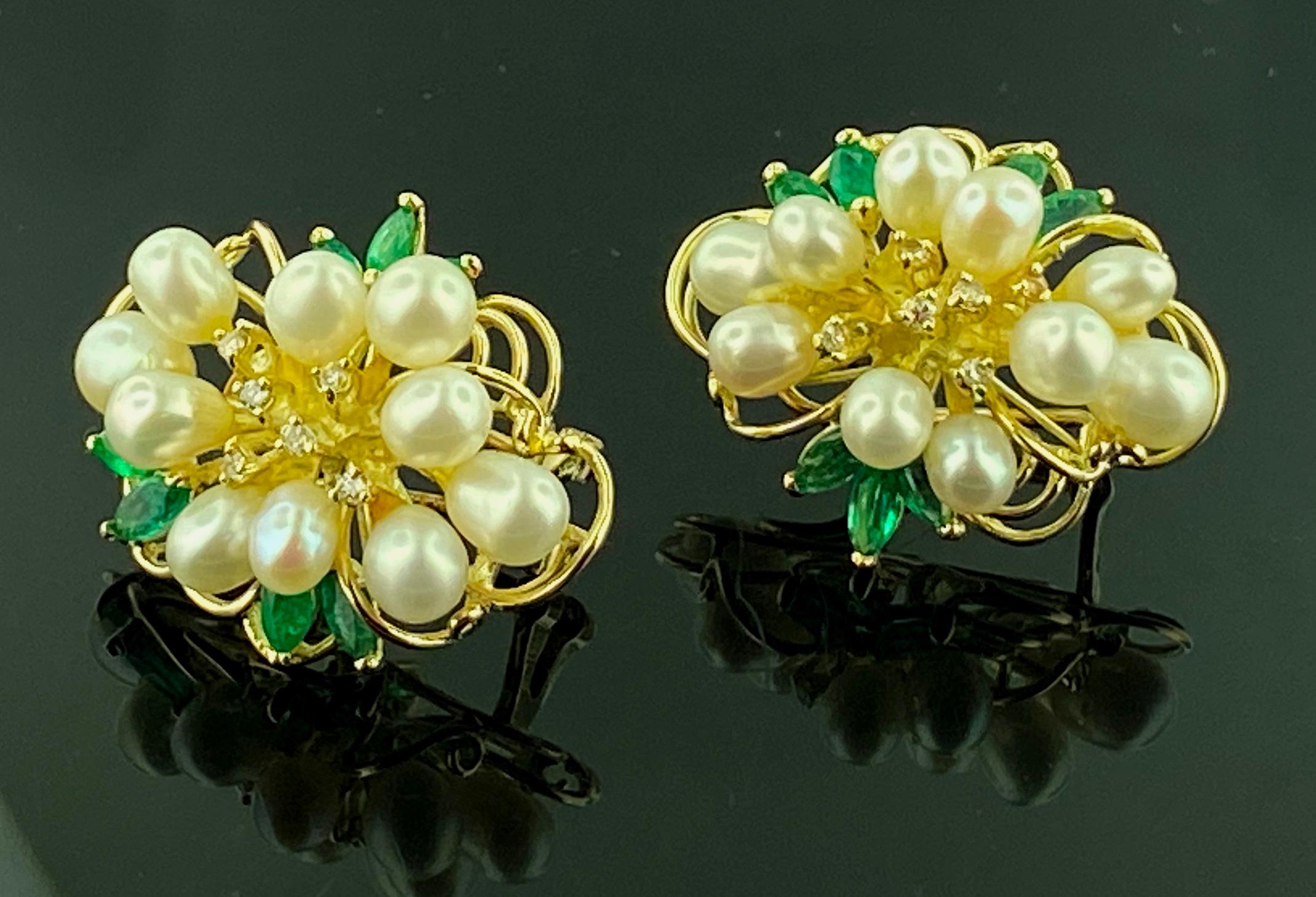 Set in 14 karat Yellow gold, weighing 10 grams, are a total of 20 Freshwater Pearls, with 12 Round Brilliant cut diamonds, weighing 0.05 carats and 14 Marquise cut Emeralds weighing 1.33 carats.