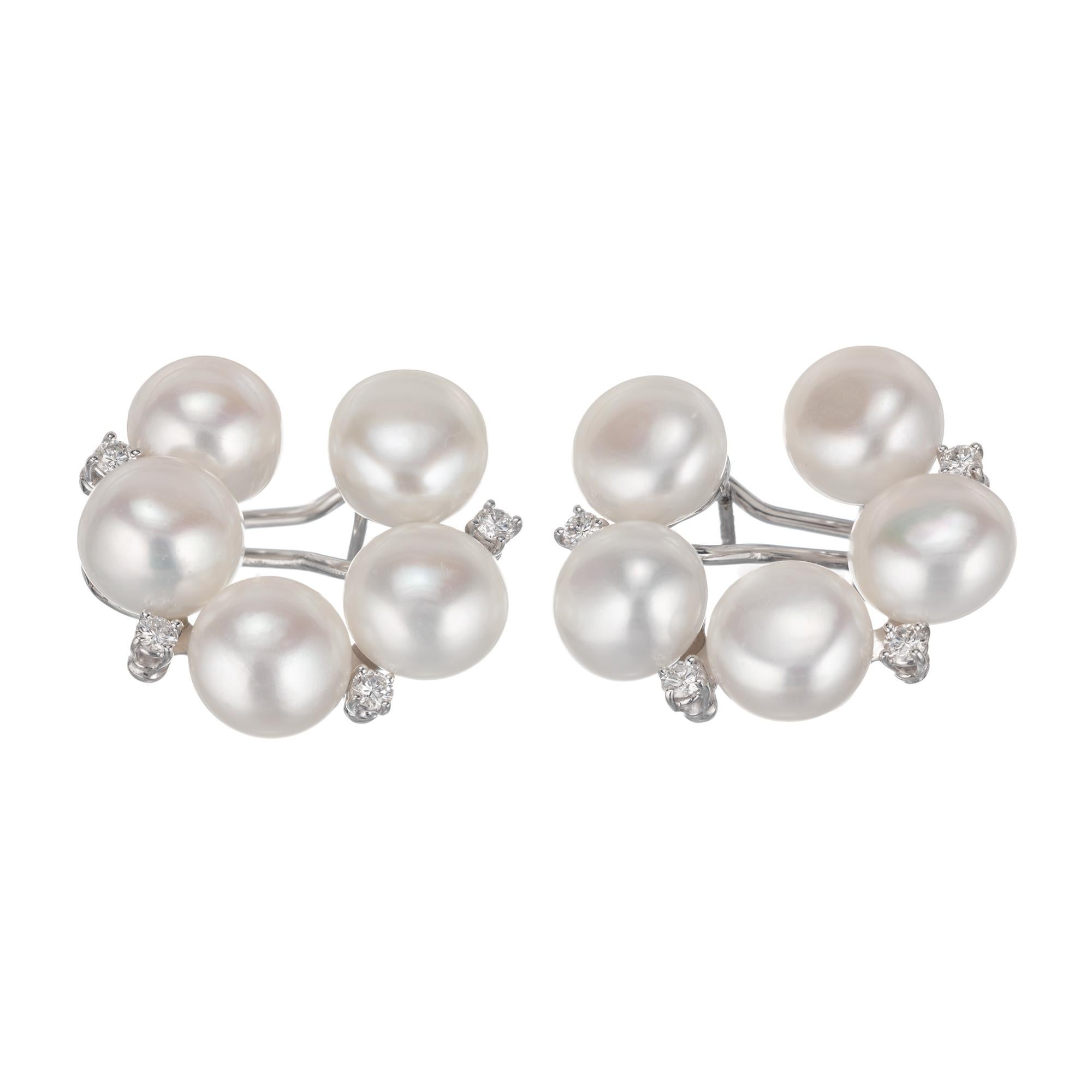 Circular clip post fresh water pearl and round diamond clip post earrings set in 18k white gold.

10 fresh water fine white cultured pearls, 11 x 7.5mm, excellent lustre and few blemishes
8 round full cut diamonds, approx. total weight .62cts, G,