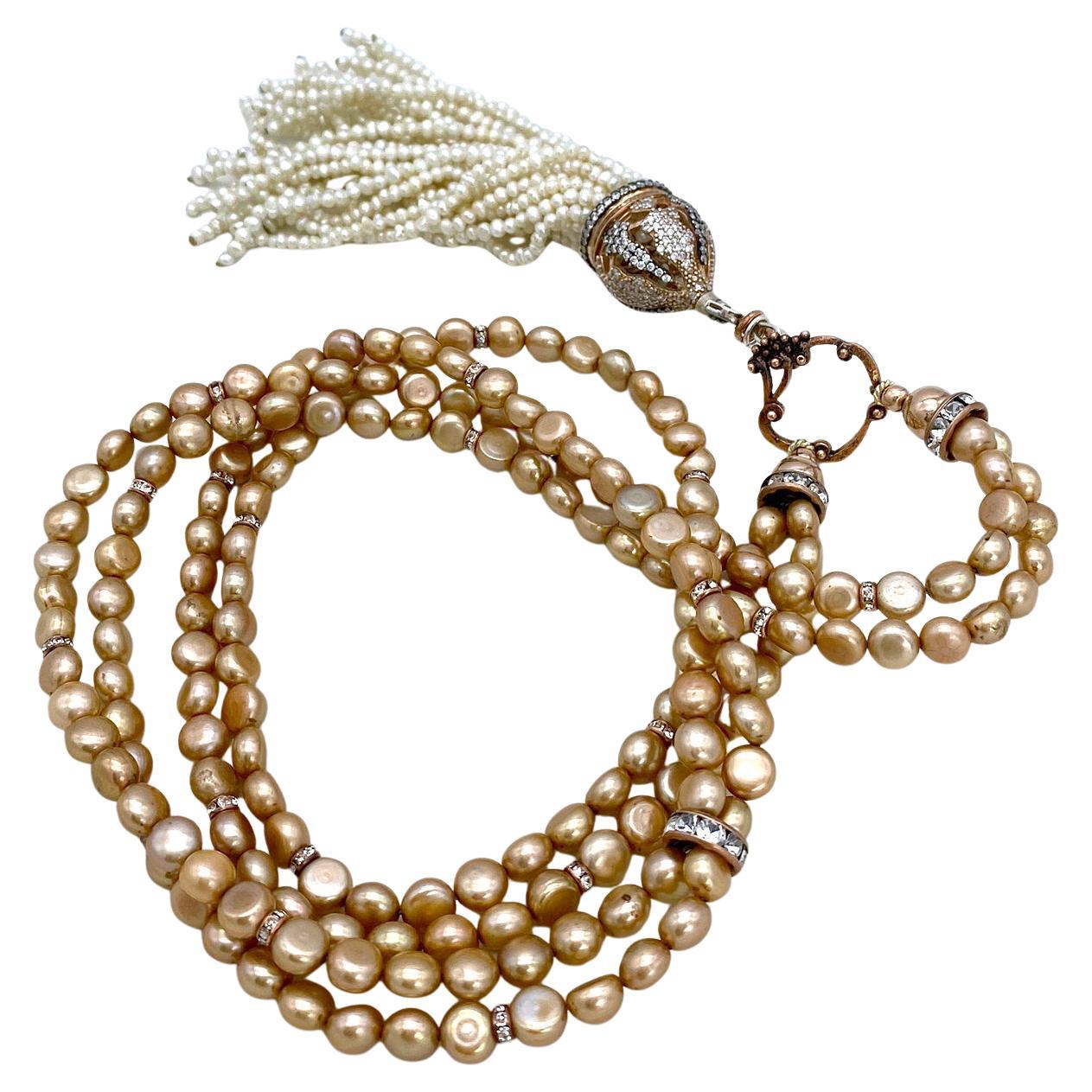 This is a freshwater pearl double strand necklace with tassel pendant. We created this long necklace with 6 mm latte colored button shaped pearls and rose gold filled components. It features a 5.25 inch seed pearl tassel pendant with sterling silver