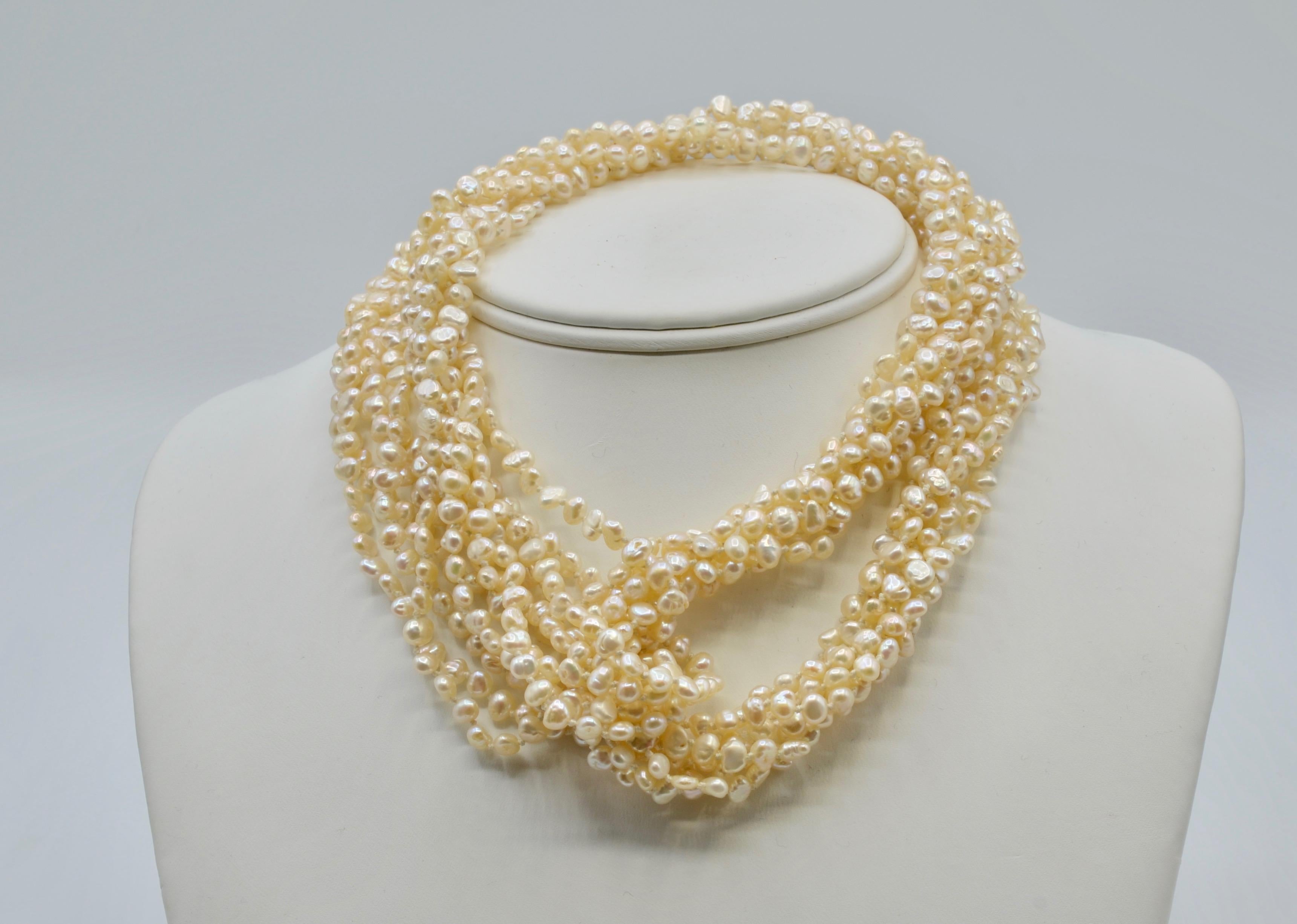This Freshwater Pearl long multistrand necklace is a great accent to any outfit. The necklace can be worn long with a dress or double up for a dramatic neckline detail. The 14 karat yellow gold clasp has a secure safety and would look fabulous in