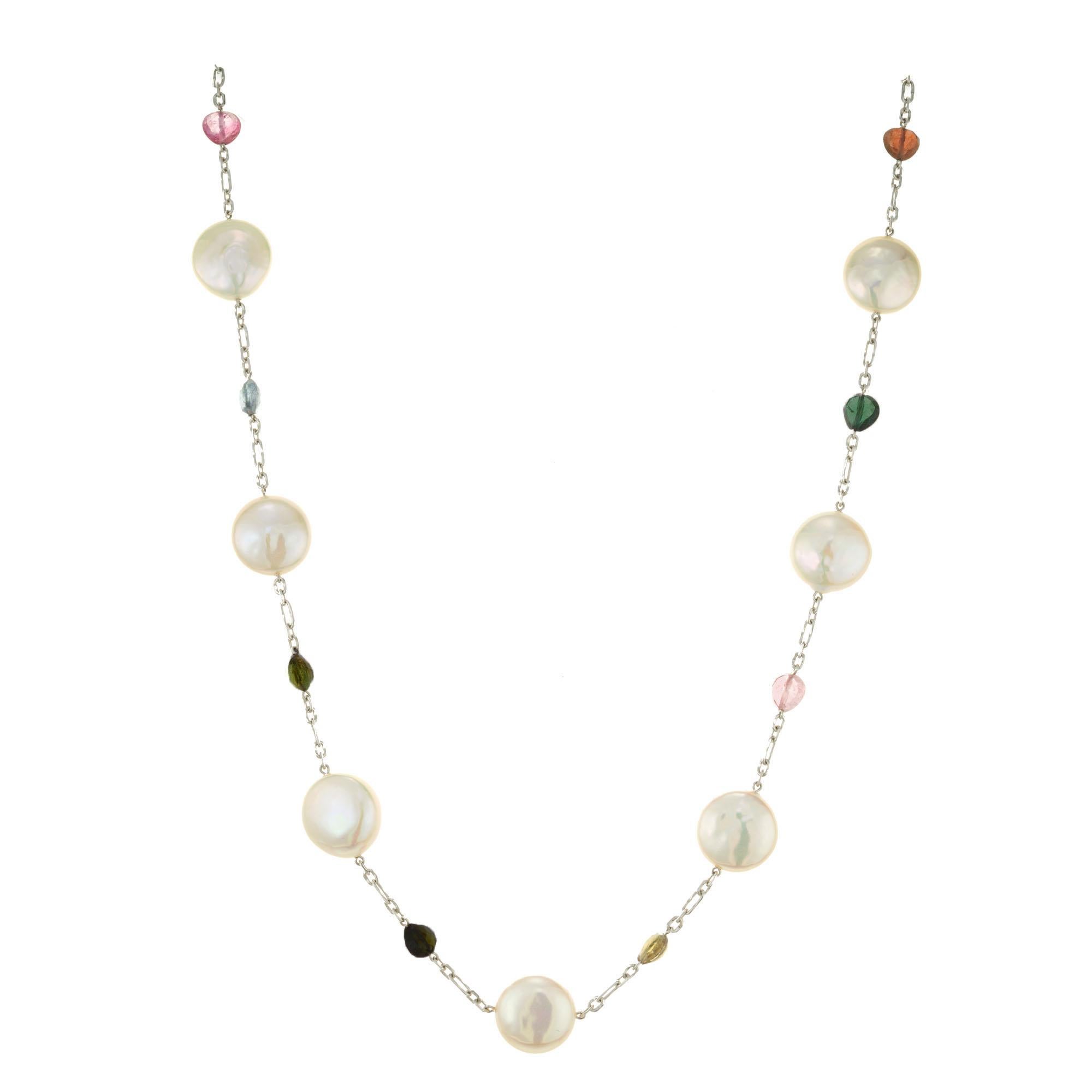 Pearl and tourmaline necklace. 10 fresh water pearls separated by 11 multi-colored tear drop shaped tourmalines. 18k white gold 20 inch link chain. 

10 fresh water round pearls 13.83mm
11 pear shape multi colored tourmalines approx. total weight.