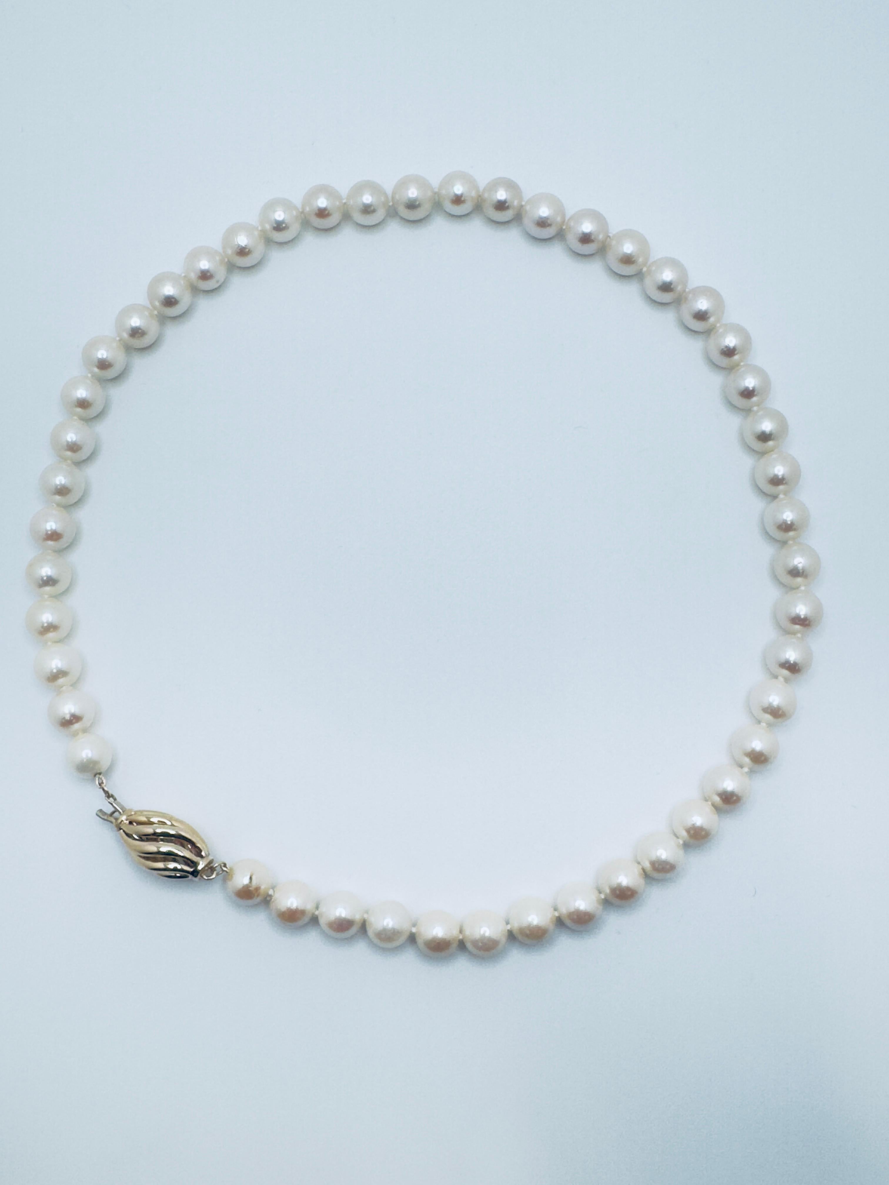 This classic freshwater pearl necklace is a timeless piece designed with elegance and refinement. It showcases 47 luminous pearls in a soft cream tone, each measuring approximately 8.5 to 9.0mm in diameter. The pearls display a consistently round
