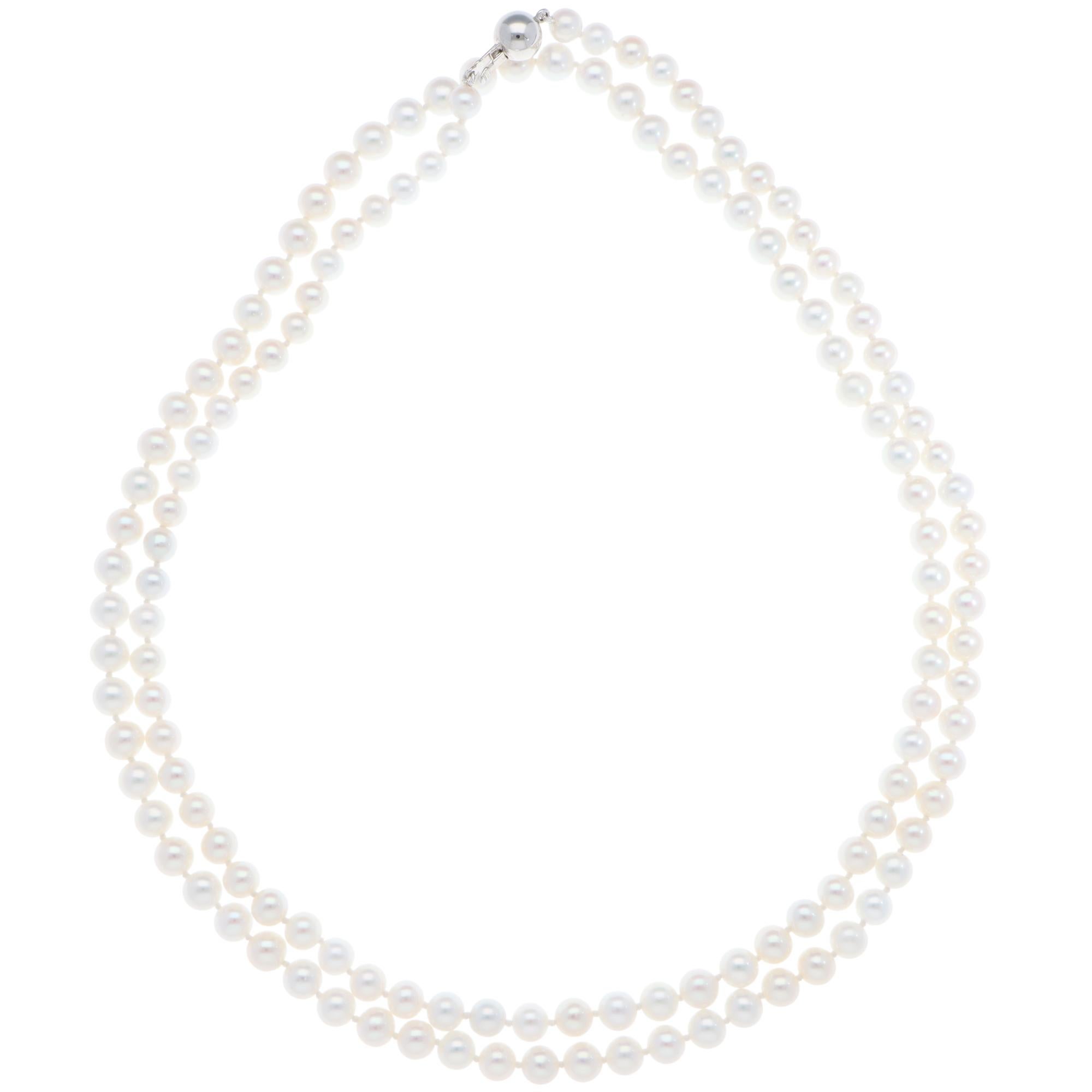 An elegant freshwater pearl strand necklace with a ball clasp in 9k white gold.

The necklace is set with 136 round freshwater pearls from Japan. The strand is knotted between the pearls to protect them from scratching each other. It is then secured