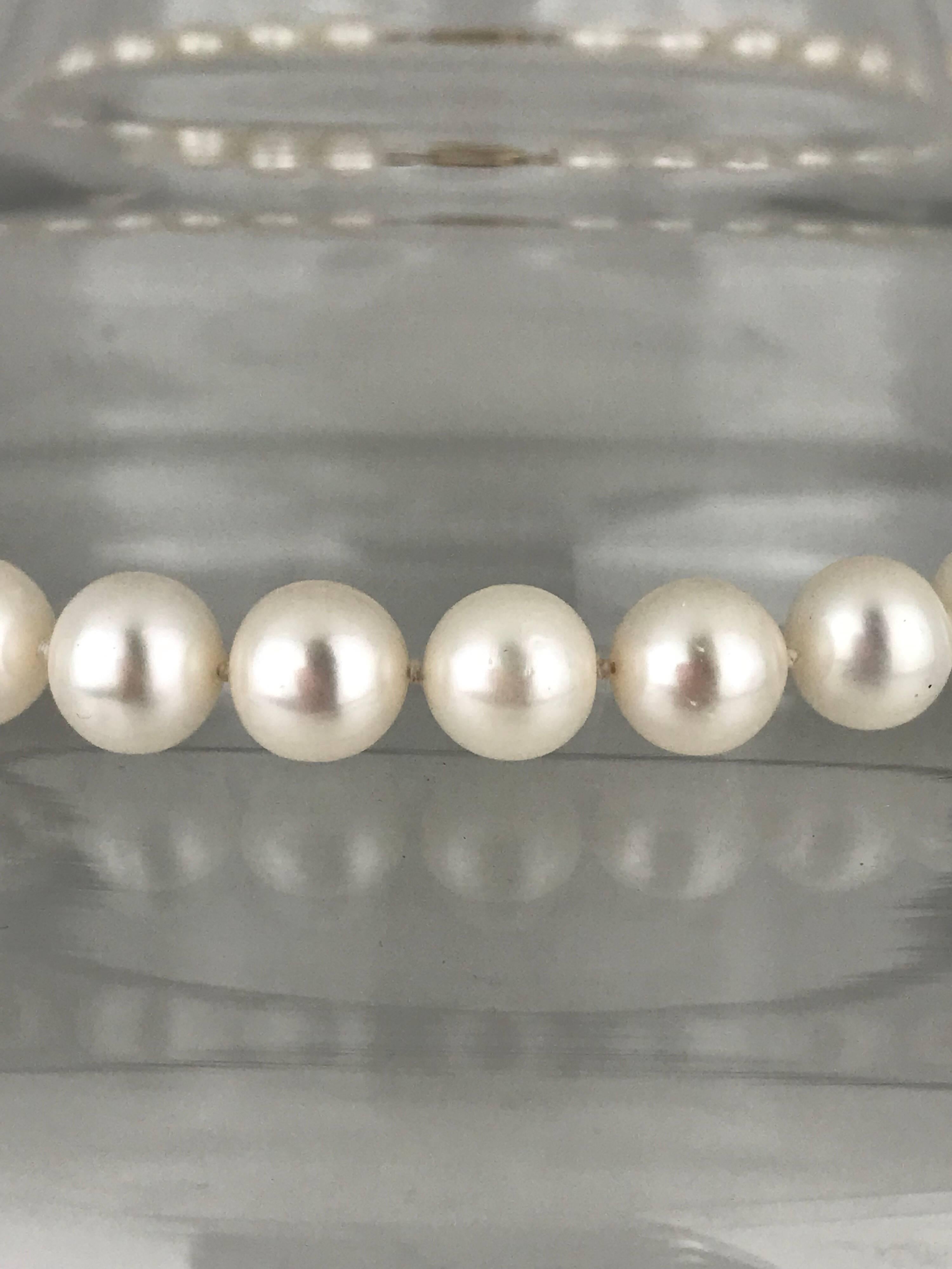 Contemporary strand of lustrous freshwater pearls is individually-knotted and fastens with a classic 14 karat yellow gold clasp.

(41) Round pearls are nicely matched and measure 9.50 - 10.50 mm each. The color of the pearls are white, nicely