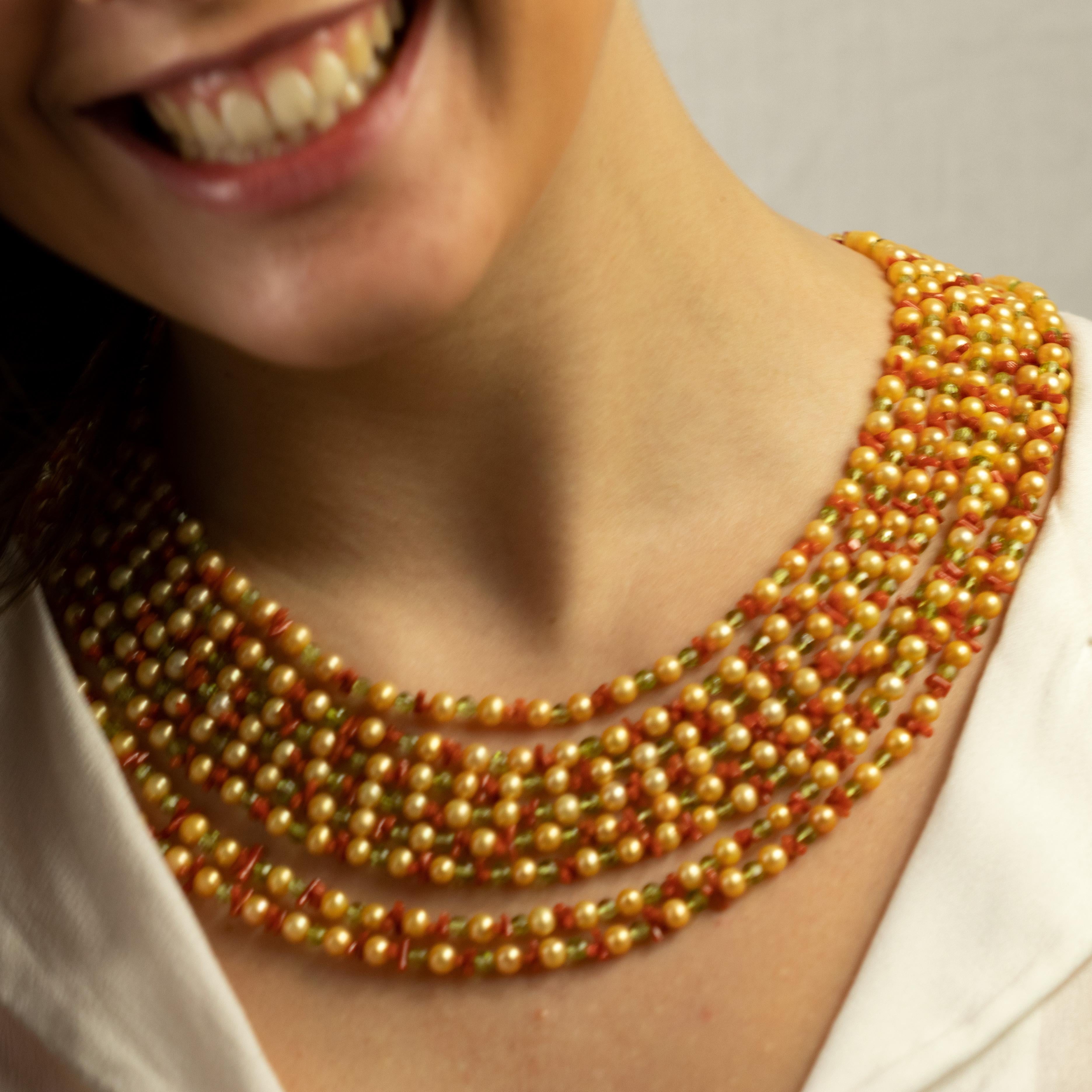 Timeless necklace wrapped in fresh water pearls, peridot and red coral that created a mix of luxury, intense color, sobriety and class.

Pearls are believed to attract wealth and luck as well as offer protection. This stunning and outstanding Iconic