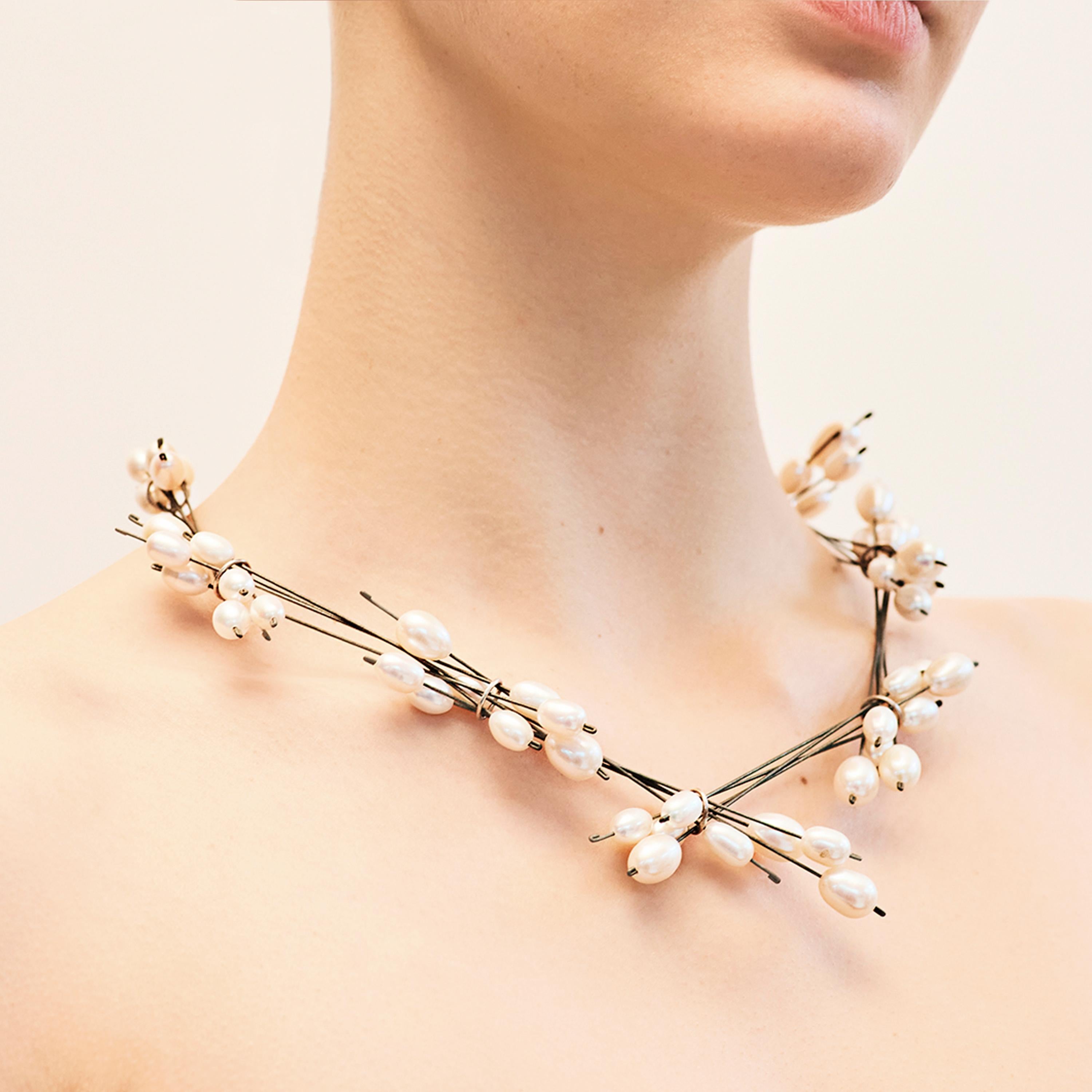 Ambroise Degenève’s Roseaux Necklace belongs to the designer’s ‘Wire’ collection. Freshwater pearls are beautifully presented on fine titanium wires. The wires are arranged in small bunches and held together by rings of silver 925, conveying a