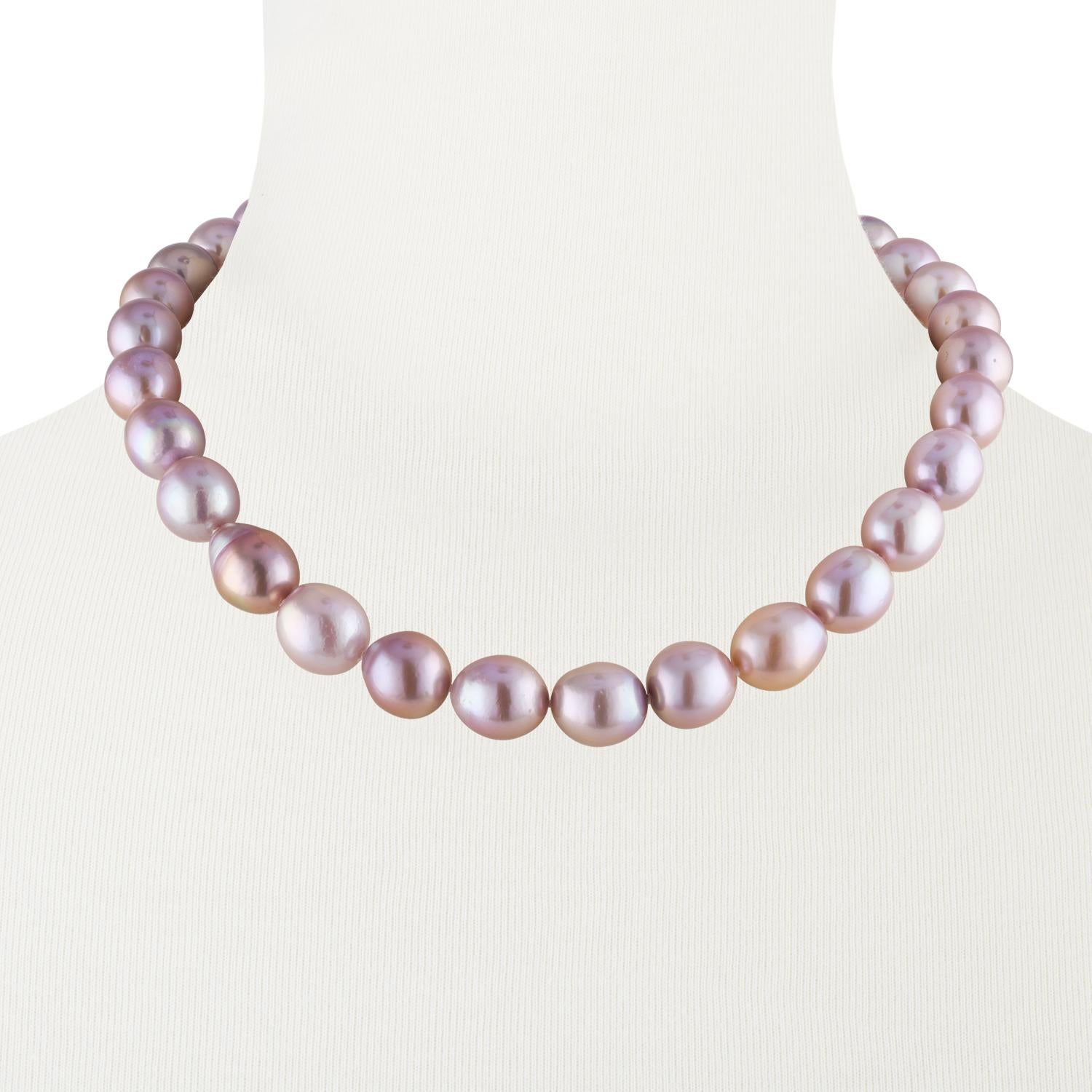 This Chinese Freshwater natural pink baroque cultured pearl necklace features fine quality, high luster pearls measuring 13x14mm.
This choker length necklace is strung with a 14 karat white gold 12mm corrugated ball clasp and is 18 inches in length.