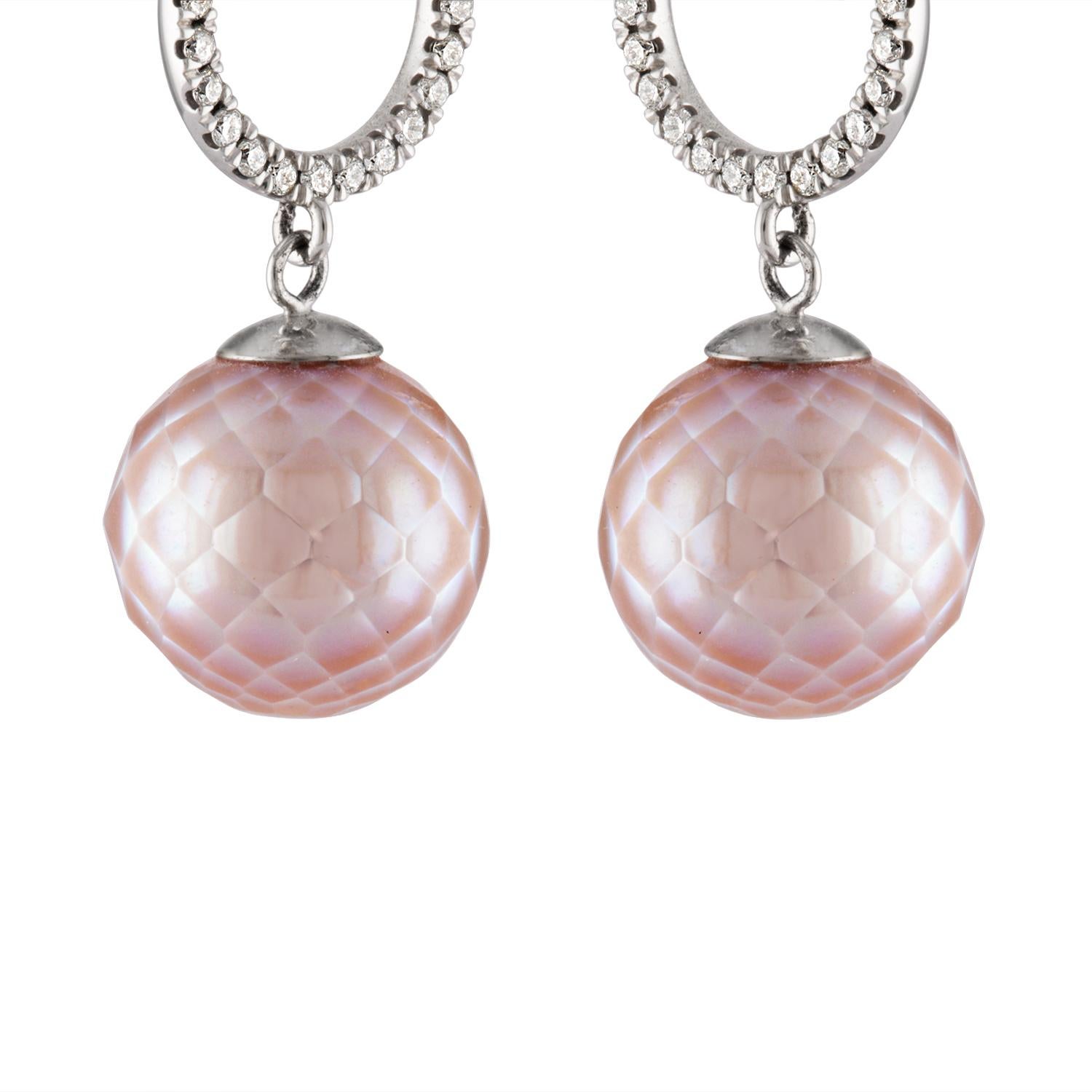 These earrings feature fine quality faceted Freshwater natural color pink cultured pearls with diamond halo tops set in 14K white gold. 
The pearls are 12mm in size. There are 0.53 carats of diamonds. 
This faceting technique is performed by skilled
