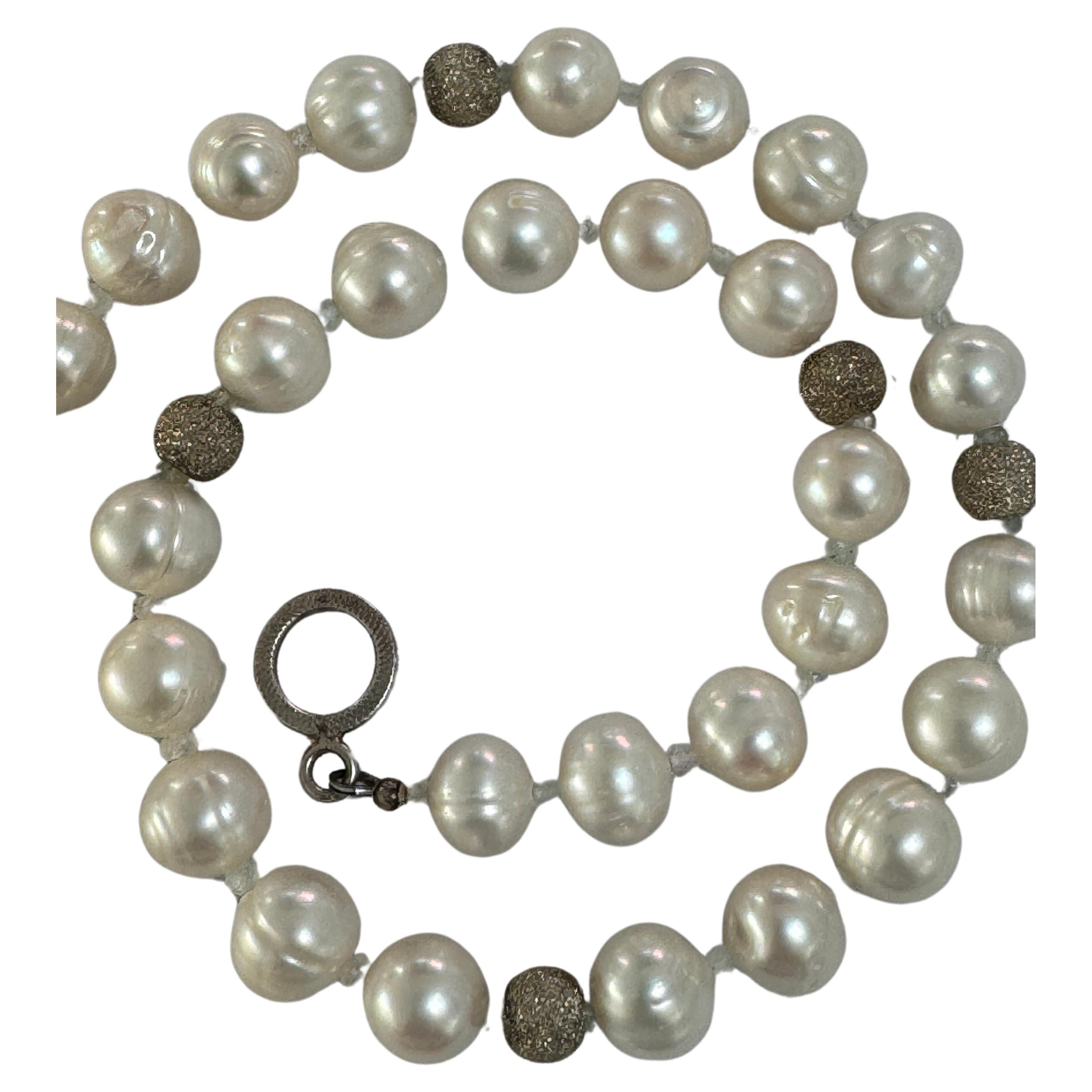 Freshwater semi round baroque white pearl small aquamarine and sterling silver beads necklace.
Handmade one of a kind delicate natural white luster about 10mm pearls combined with natural tiny aquamarine beads, accented with 5 sterling silver round