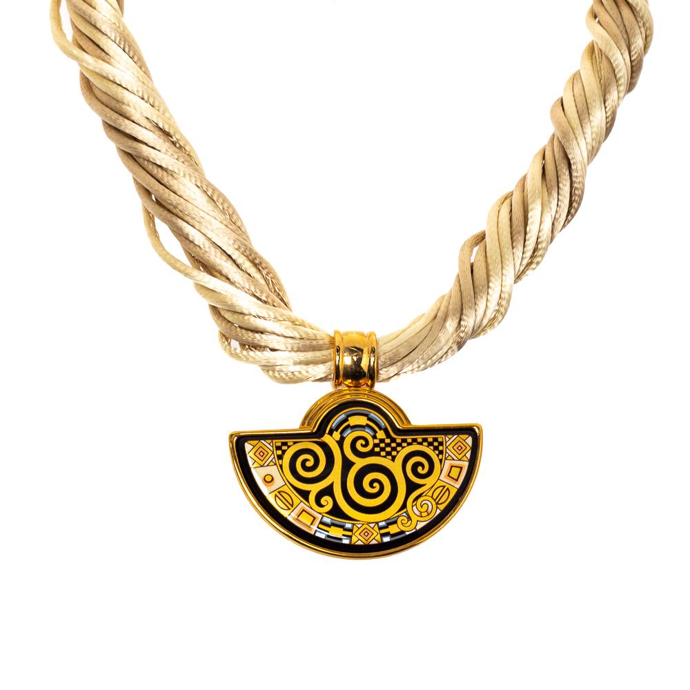 This beauty from Frey Wille is exquisite and perfectly designed to impress! Beautifully crafted from gold-plated metal, this necklace is a stunner. It has been styled with a half-moon pendant designed with fire enamel while being held by silk cords