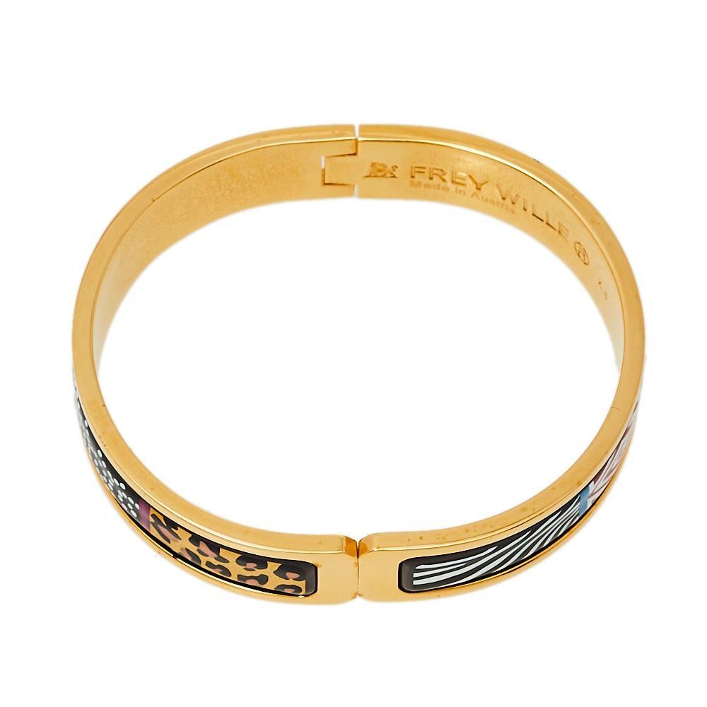 Frey Wille’s ‘Spirit of Africa Safari’ Ballerina bracelet is designed with careful construction and unique elements. The bracelet in gold-plated metal has a simple shape, a comfortable fit, and stunning enamel work along its center.

Includes: Info