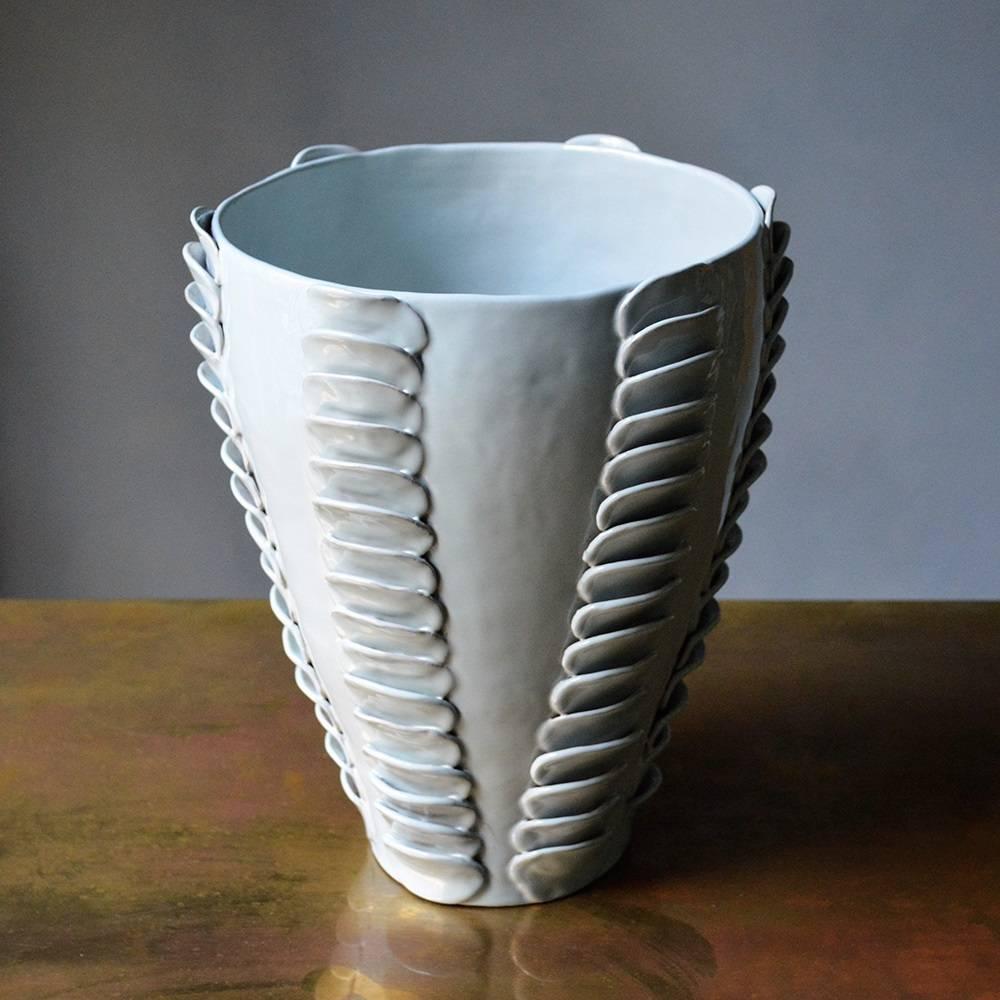 Masterfully glazed and completely handmade using the colombino technique, this sophisticated terracotta vase is part of the Frida collection. It features a simple shape with an ample opening and a soft pale blue glossy finish. The exquisite