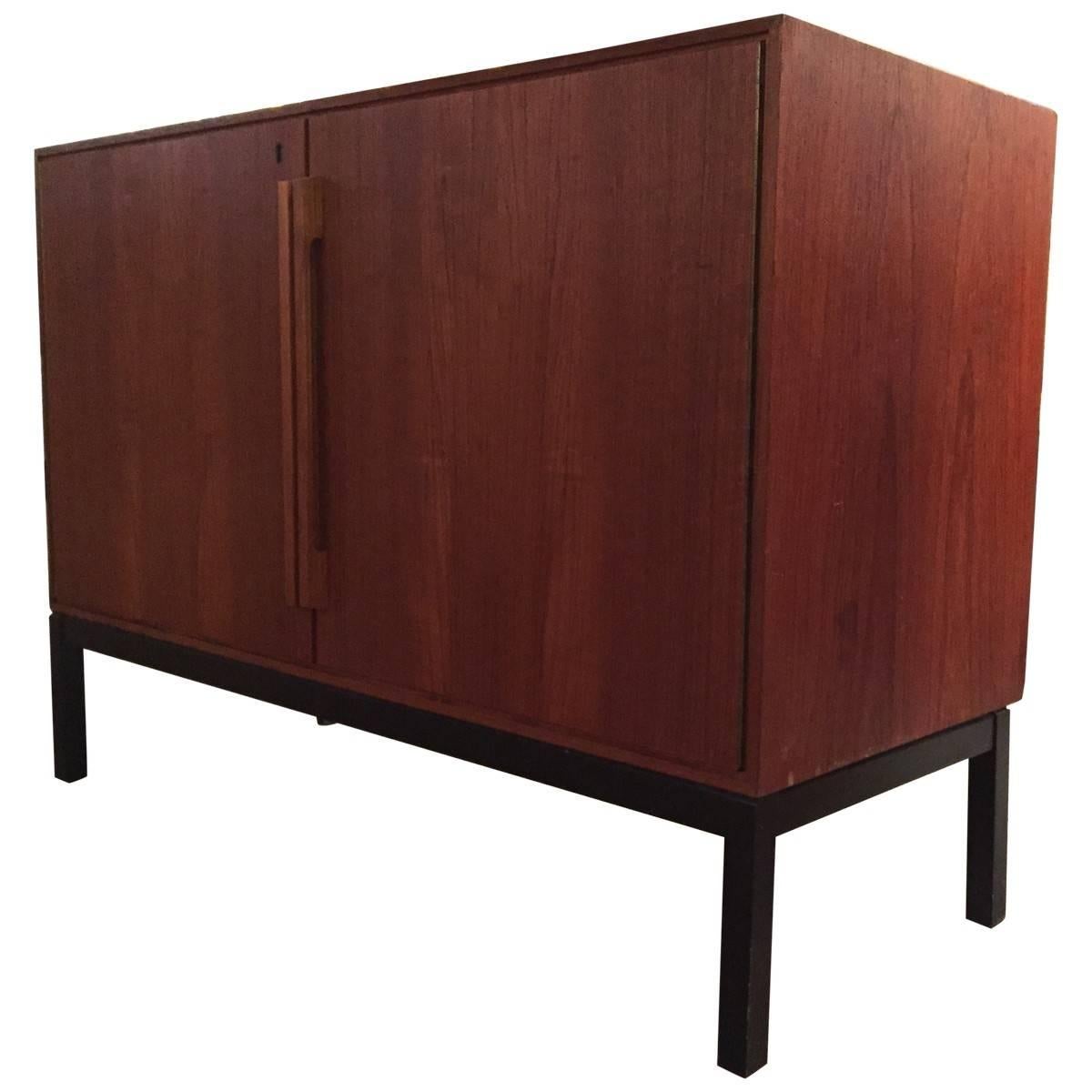 Midcentury emblematic of the craftsmanship and efficient design that defines Danish Mid-Century Modern furniture, this sleek bar cabinet adds the perfect stylish touch to any living space. As a convenient bonus, the piece also includes a perfectly