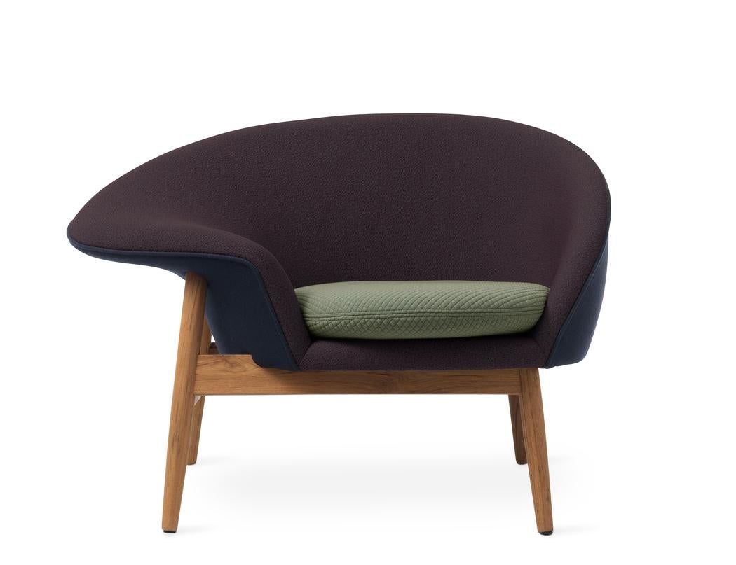 Fried egg left lounge chair dark blue eggplant light sage by Warm Nordic
Dimensions: D99 x W68 x H 68 cm
Material: Textile or nubuck upholstery, Solid oiled teak
Weight: 25 kg
Also available in different colours and finishes. 

A unique asymmetrical