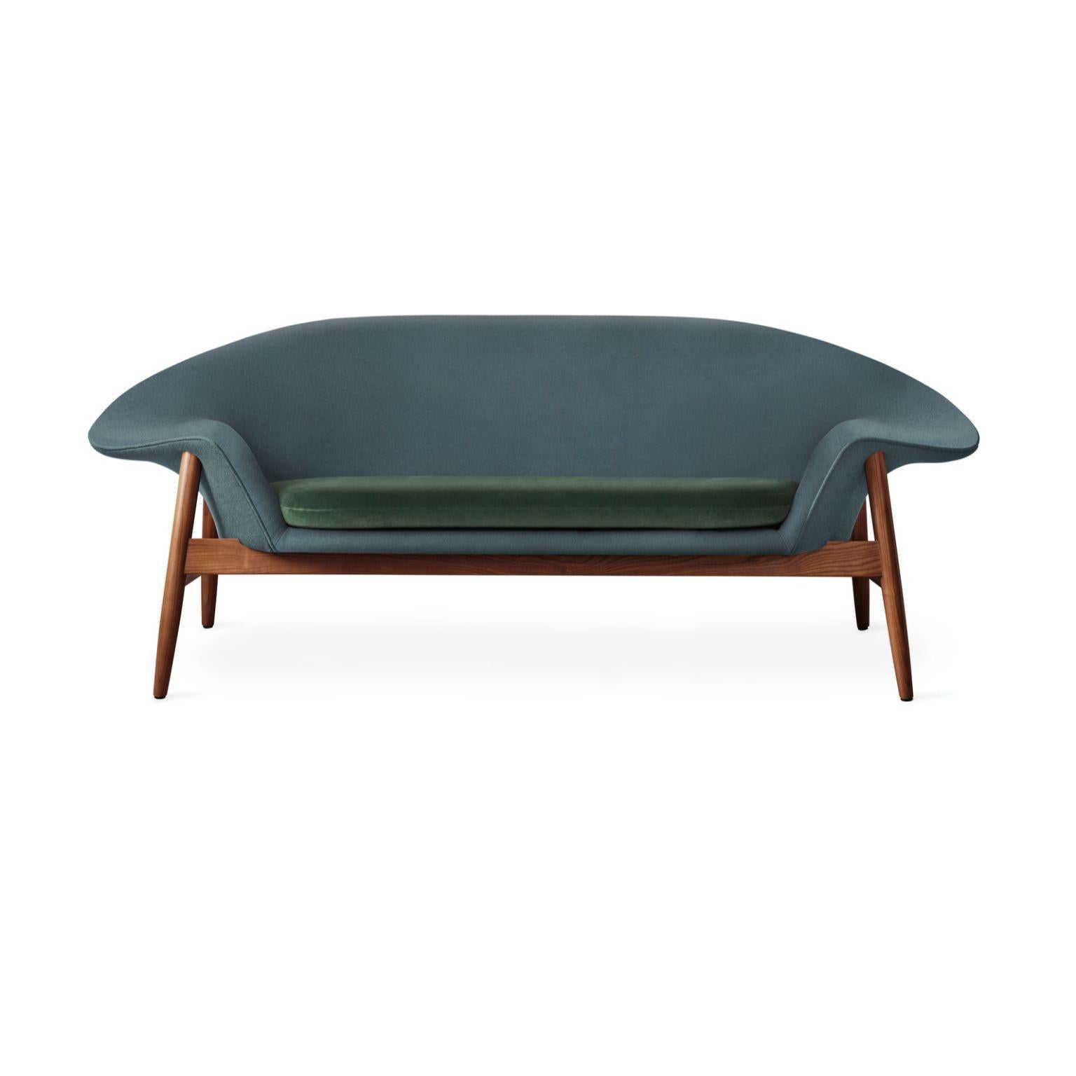 Fried egg sofa petrol forest green by Warm Nordic
Dimensions: D 186 x W 68 x H 68 cm
Material: Textile upholstery, Solid oiled teak
Weight: 42 kg
Also available in different colours and finishes.

Warm Nordic is an ambitious design brand