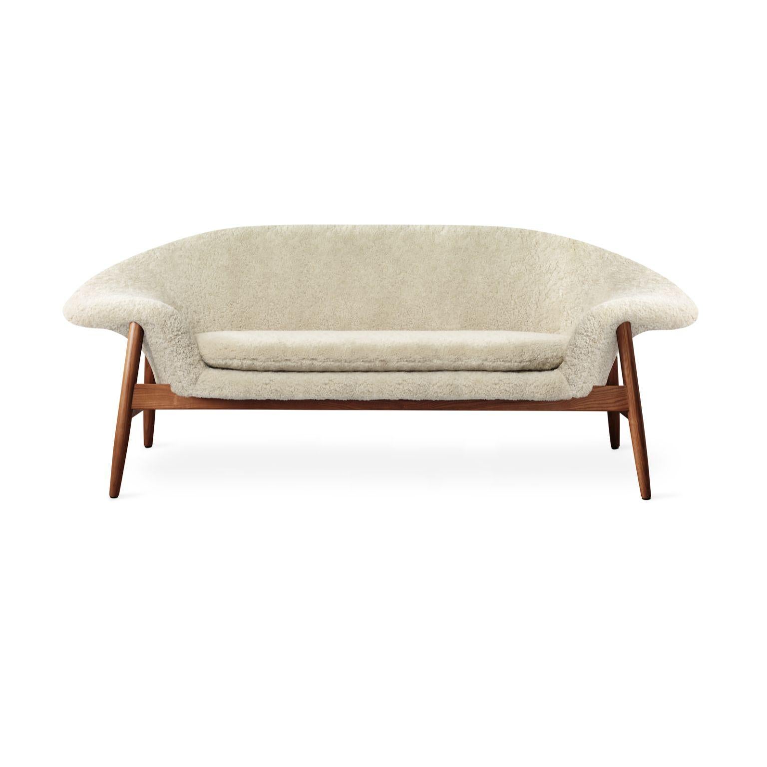 Fried egg sofa sheepskin moonlight by Warm Nordic
Dimensions: D 186 x W 68 x H 68 cm
Material: Sheepskin upholstery, Solid oiled teak
Weight: 42 kg
Also available in different colours and finishes.

Warm Nordic is an ambitious design brand