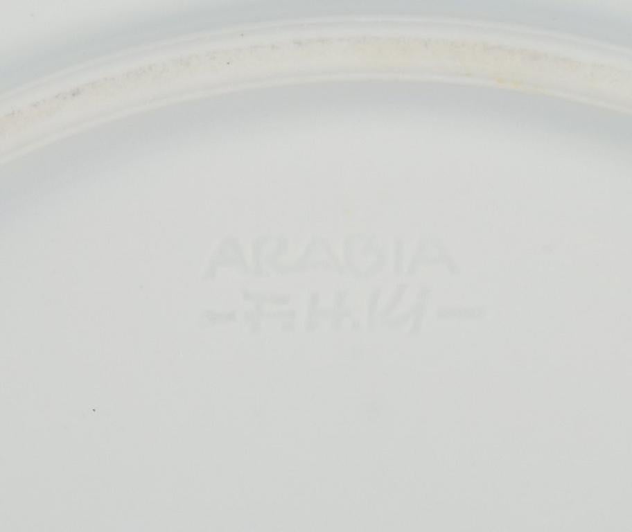 Finnish Friedl Holzer-Kjellberg for Arabia, Finland. Eight plates in rice porcelain.
