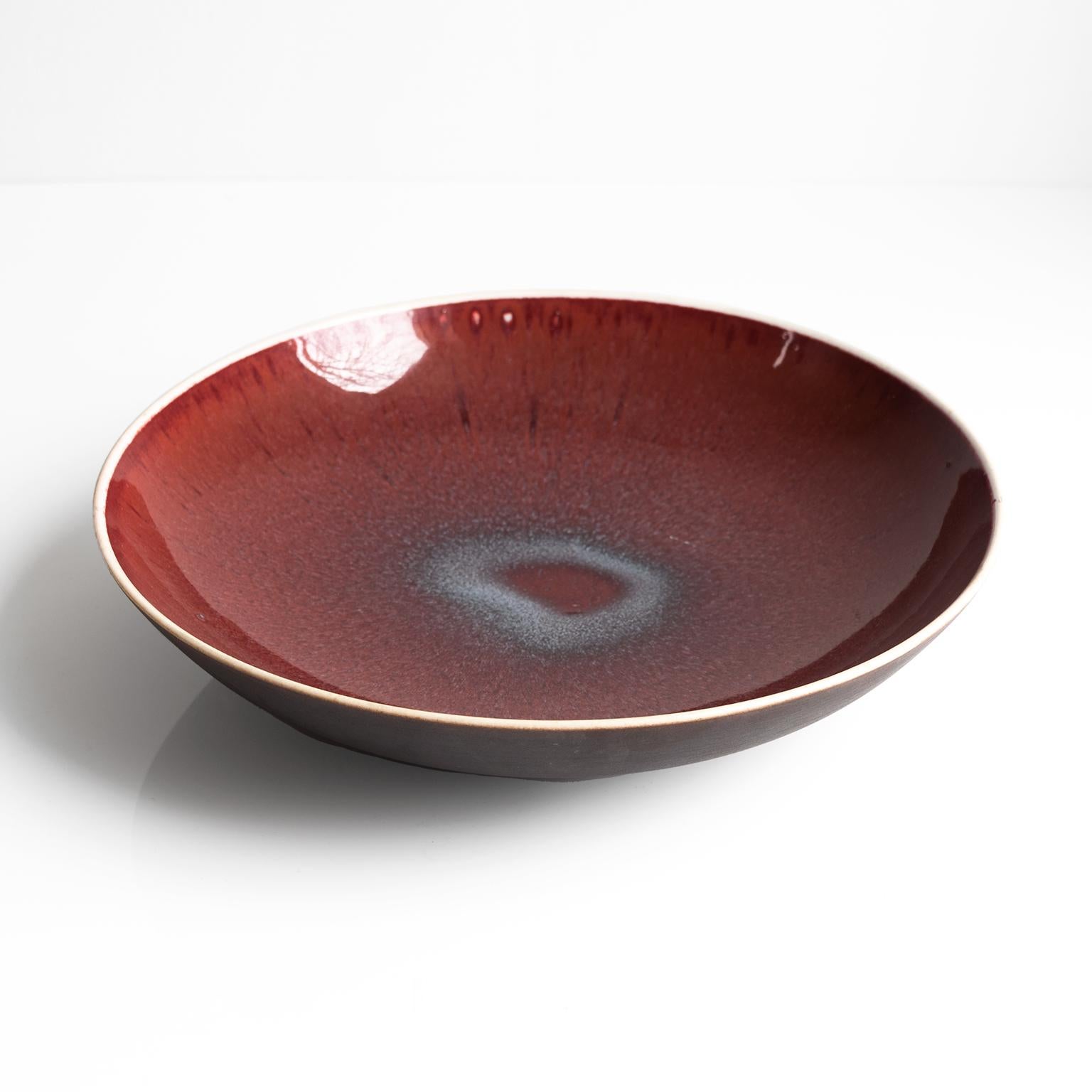 Scandinavian Modern ox-blood glaze hand thrown footed bowl by Friedl Kjellberg for Arabia, Finland. 1950's Signed on bottom

She is known to have been inspired and influenced throughout her life by the methods and shapes of Chinese ceramics.