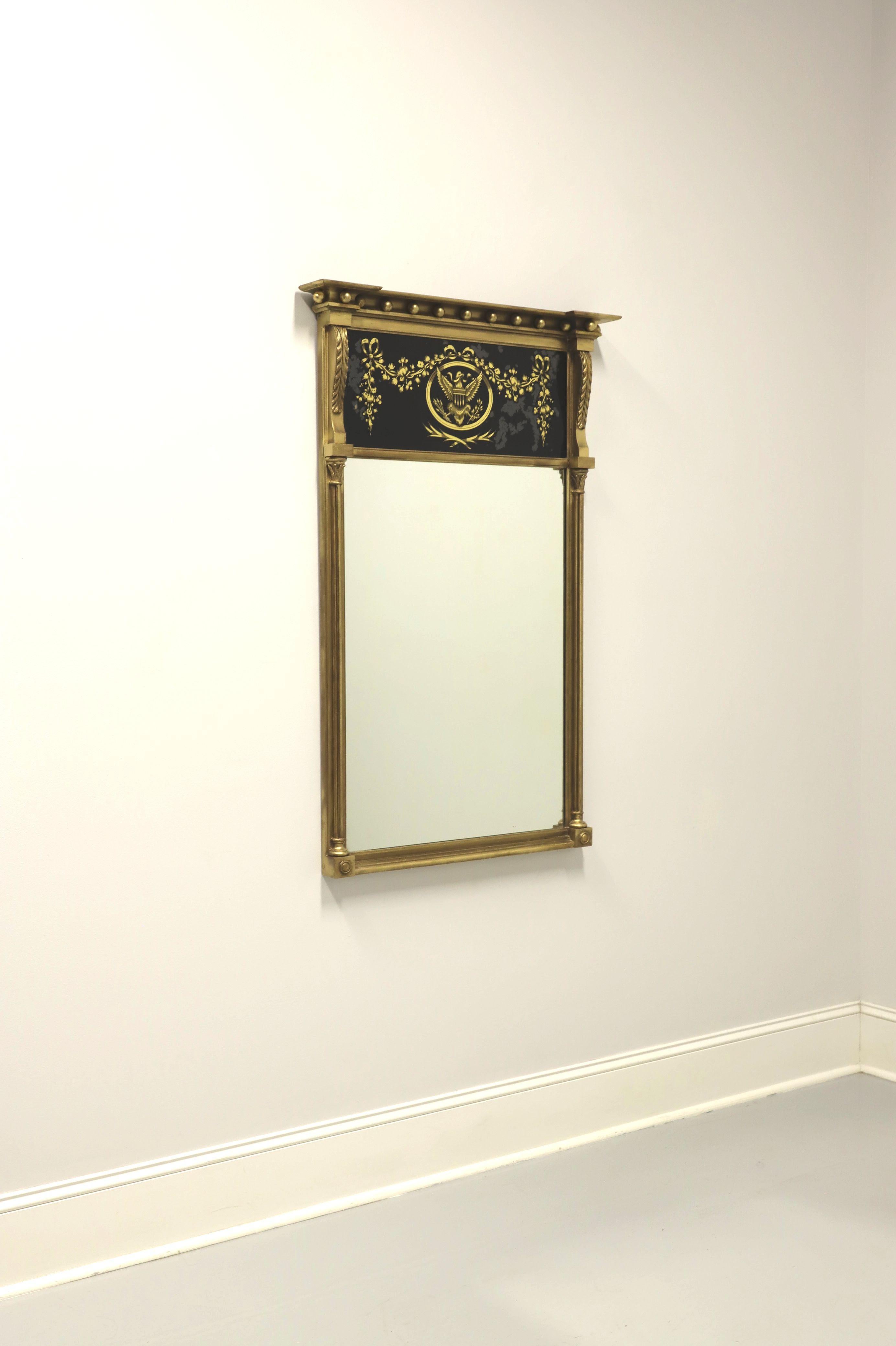 A vintage Federal style Trumeau wall mirror by Friedman Brothers. Mirror glass in a tall giltwood frame with an eglomise top panel, a reverse painted black & gold eagle seal with garland. Made in the USA, in the mid 20th century.

Measures: 31 W 4