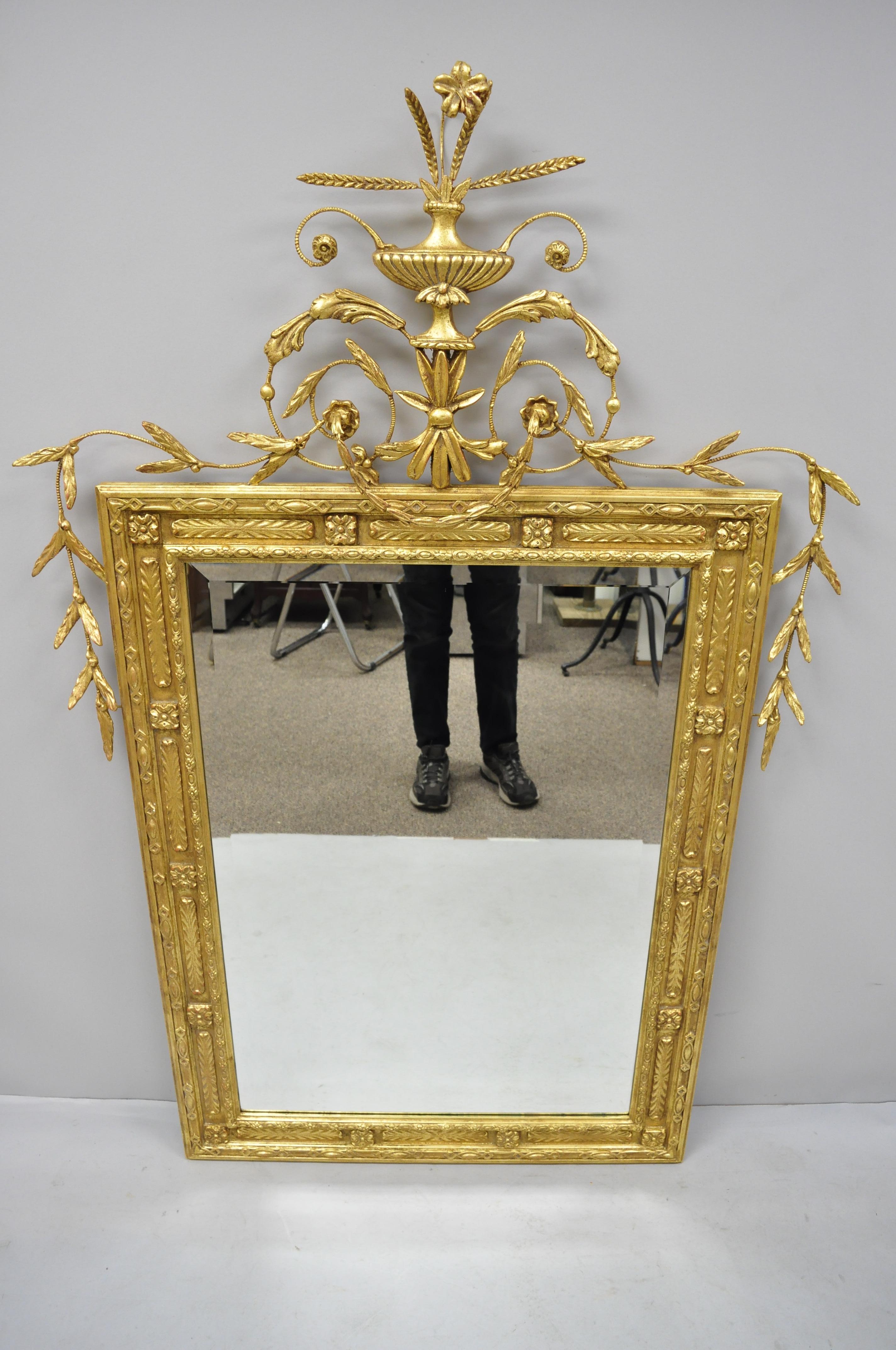 Friedman Brothers large gold gilt Adams style beveled mirror. Item features urn and leafy crown, gold gilt frame, beveled glass central mirror, original label, great style and form, circa late 20th to early 21st century. Measurements: 64
