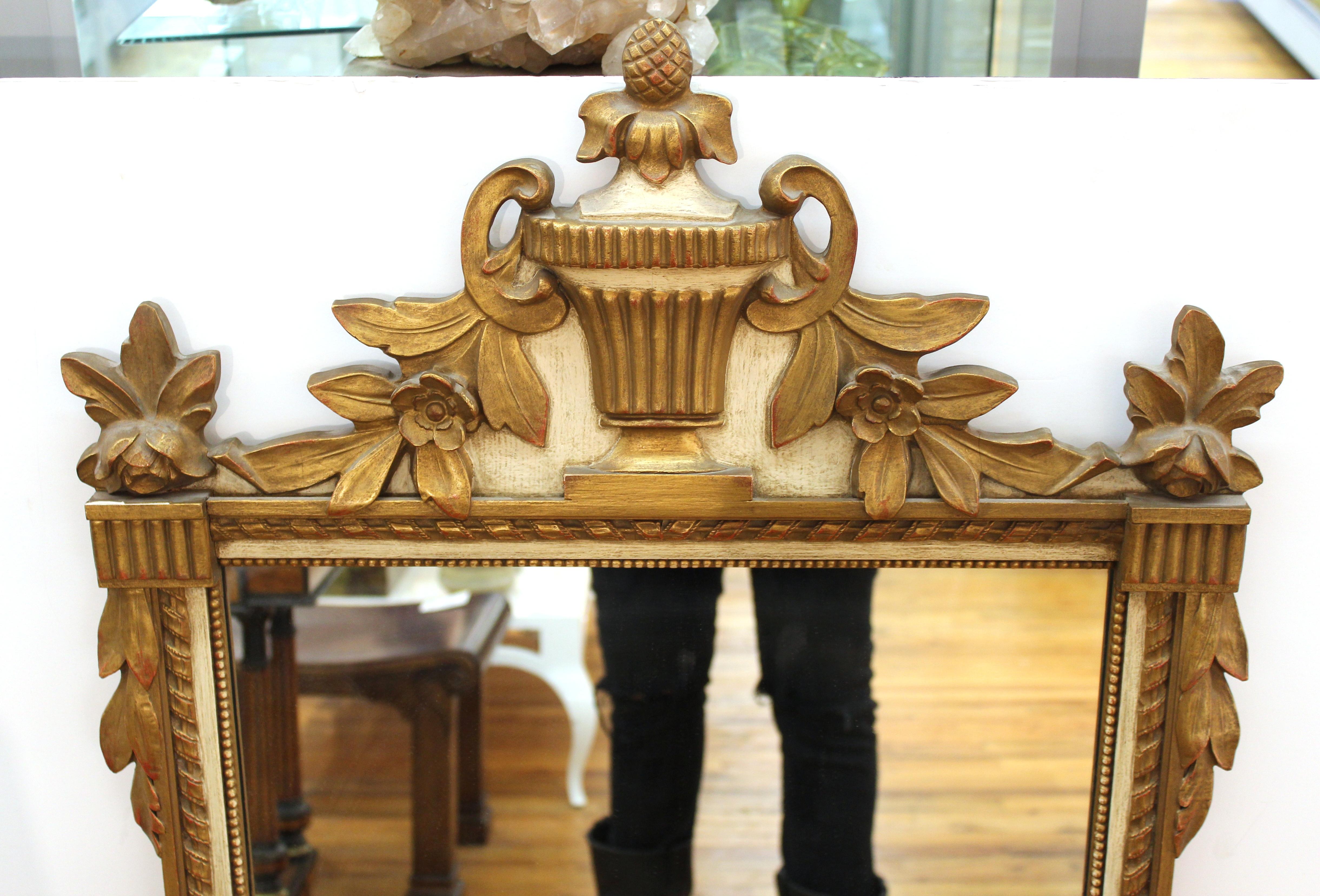 Friedman Brothers mid-century Hollywood Regency wall mirror with neoclassical style ornaments and original paper label on back from 'F. B. Decorative Arts Inc. New York'.